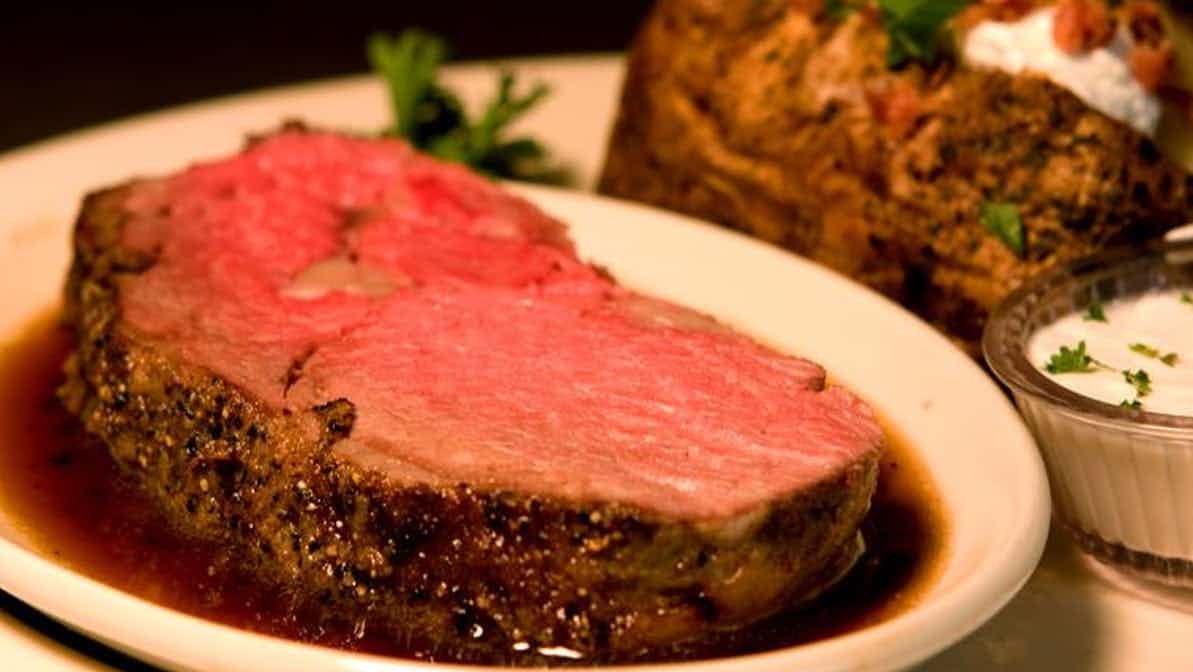 Juicy prime rib with a heaping baked potato, served courtesy of Jakers in Idaho Falls of the Yellowstone Teton Territory.