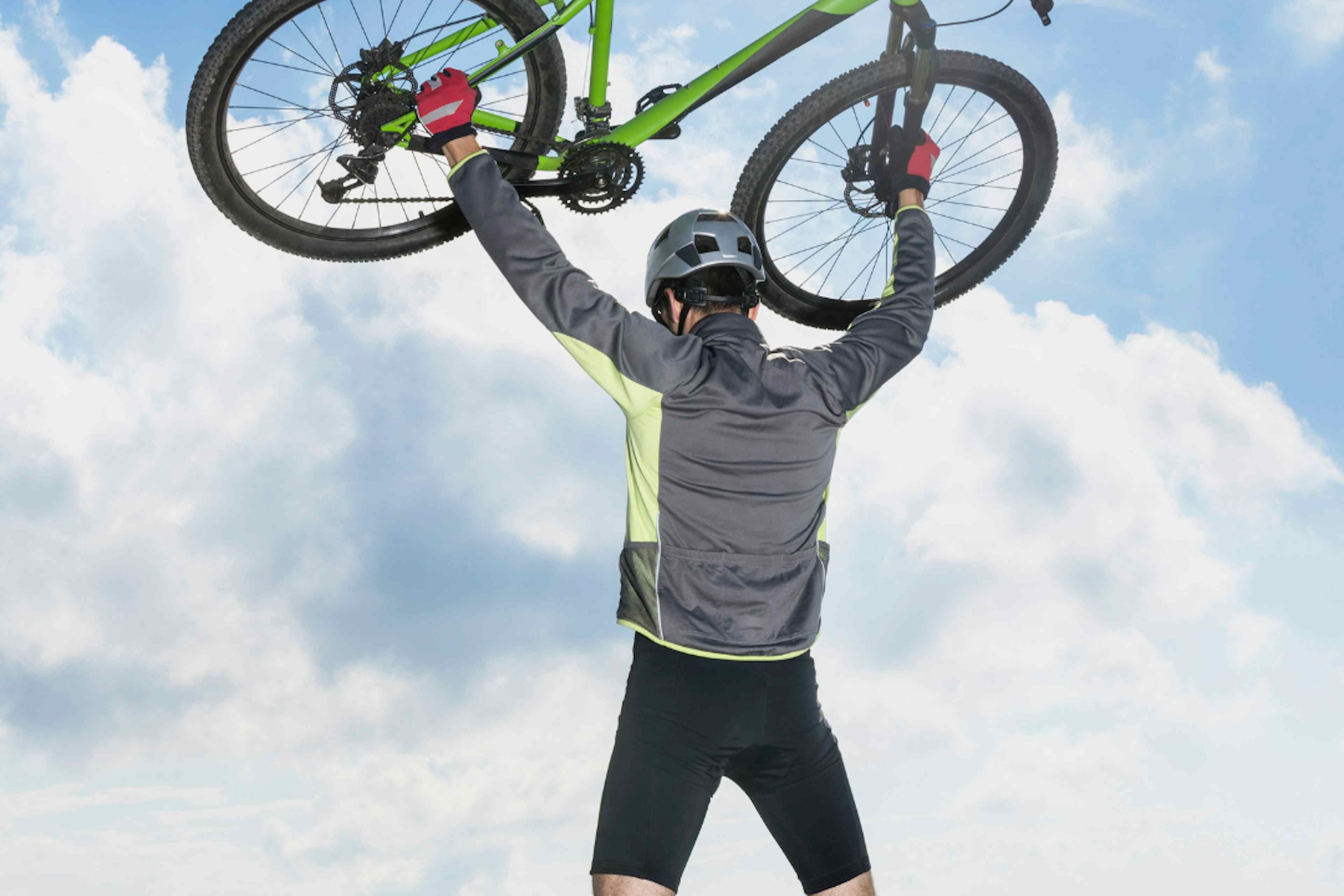 A biker lifts his bike in Ashton Idaho, a part of Eastern Idaho and Yellowstone Teton Territory.