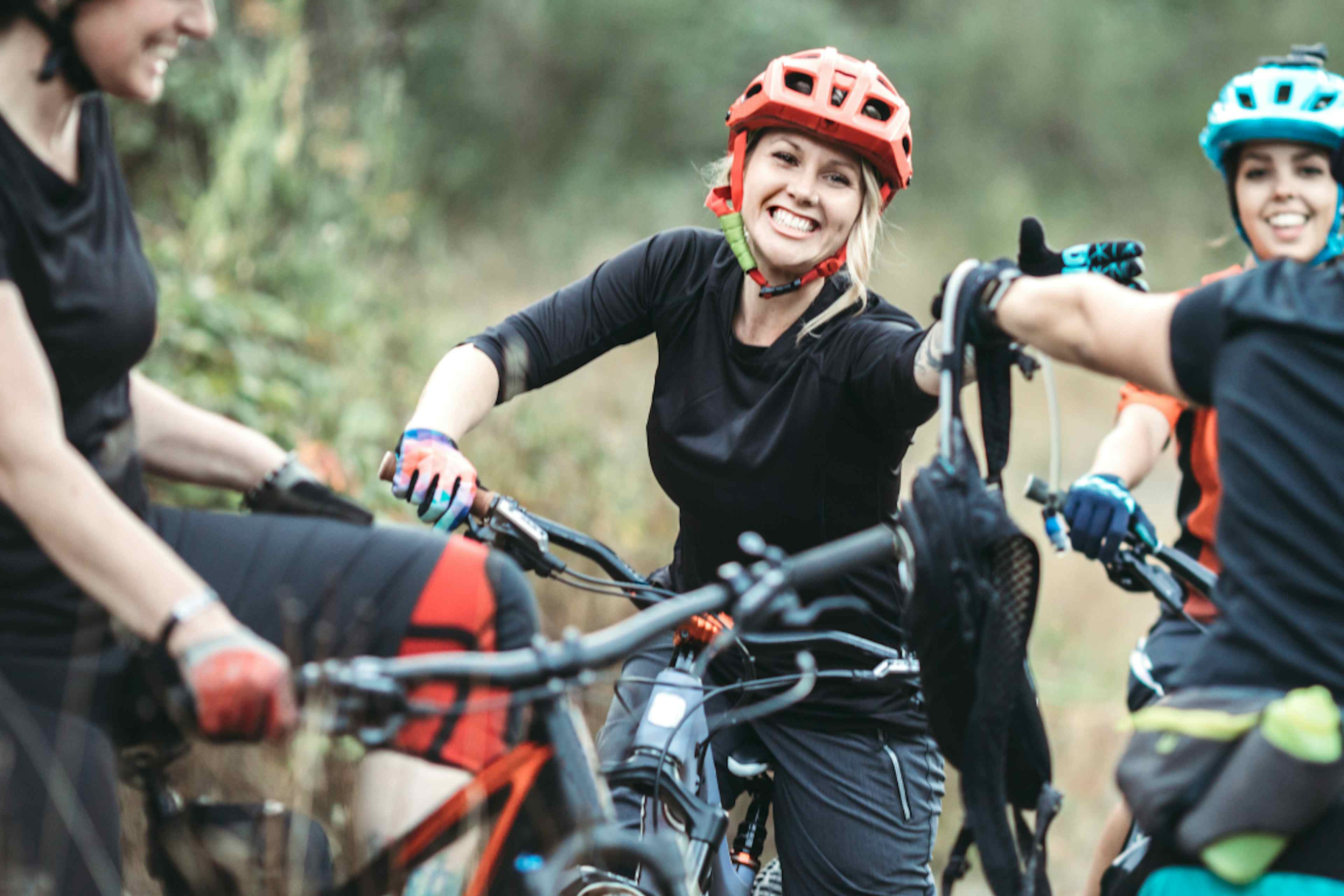 A group of women share a camelback on a biking trail in Island Park, Idaho a part of Eastern Idaho.
