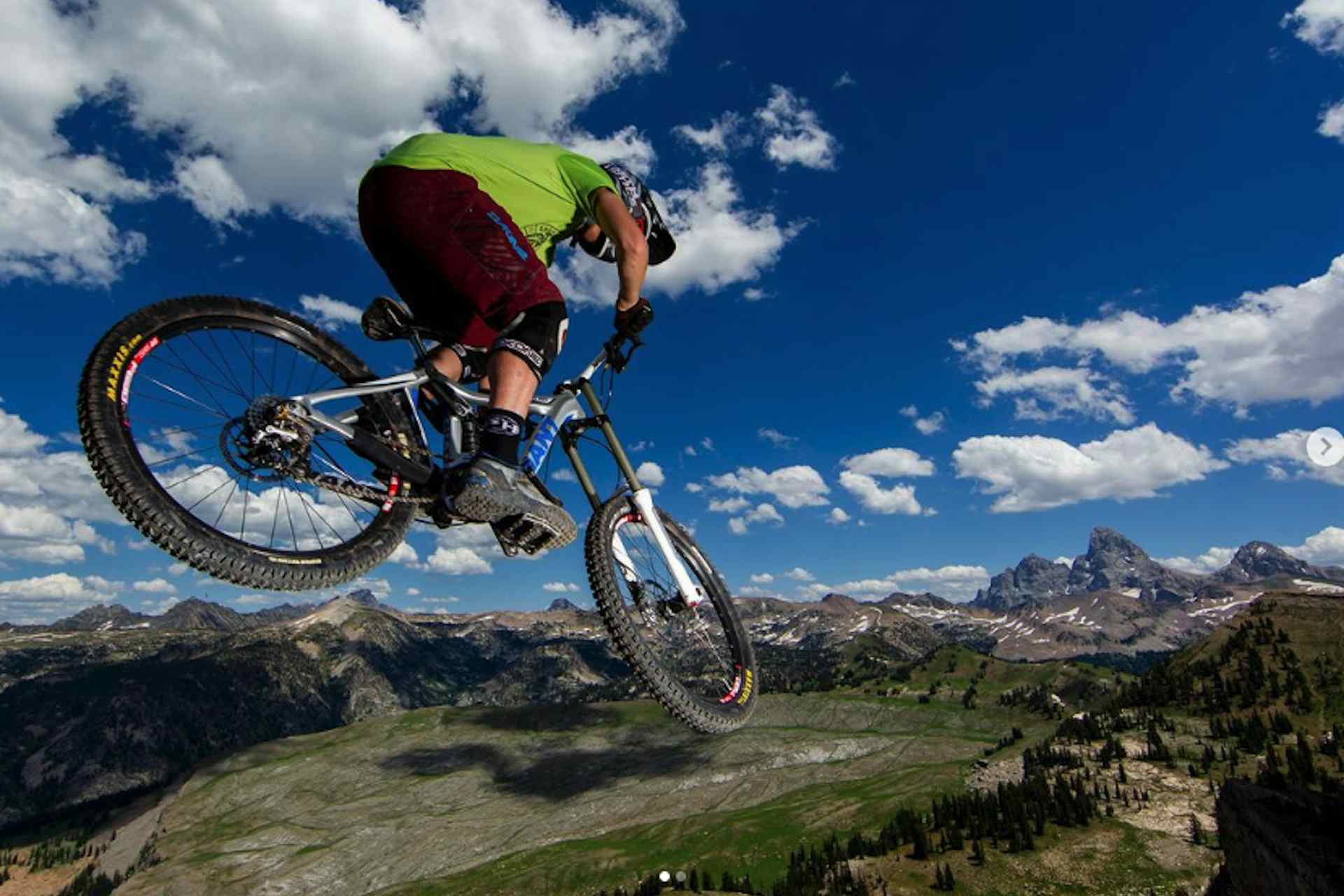 Mountain Biker at Grand Targhee Resort in front of the Teton Mountains in Eastern Idaho, a part of Yellowstone Teton Territory.