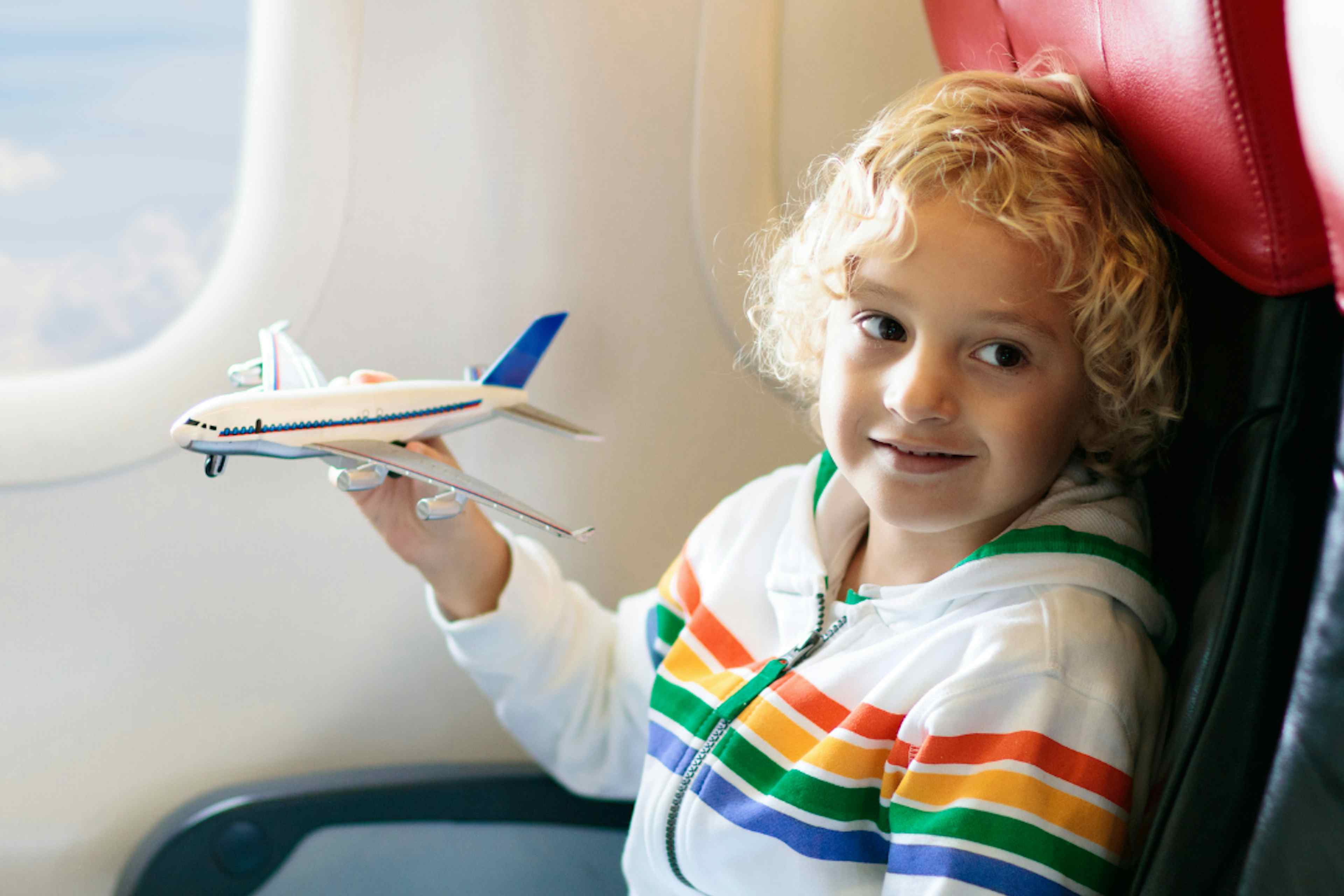 A child holds a toy plane flying into Idaho Falls Regional Airport in Idaho Falls ID, a part of Yellowstone Teton Territory.