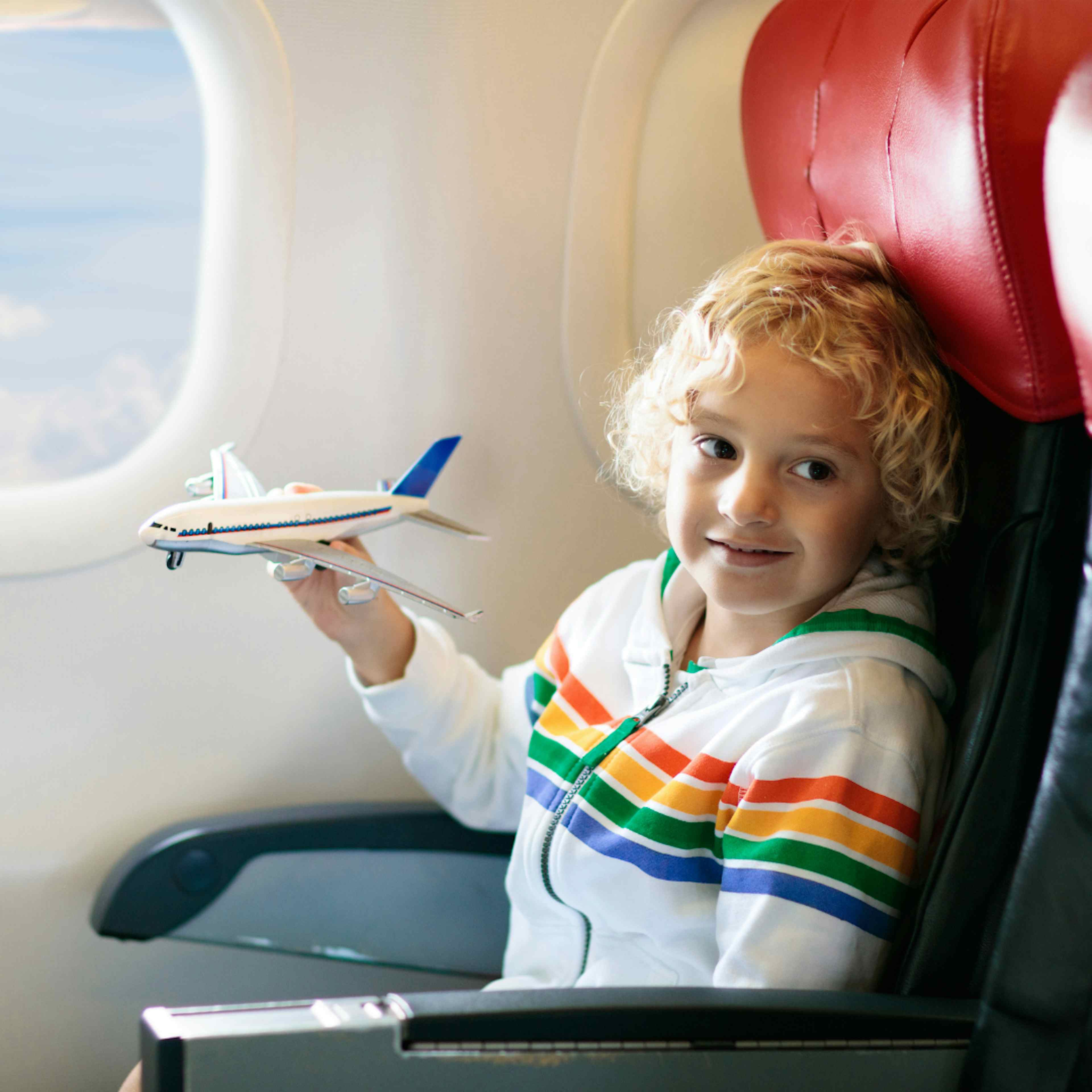 A child holds a toy plane flying into Idaho Falls Regional Airport in Idaho Falls ID, a part of Yellowstone Teton Territory.