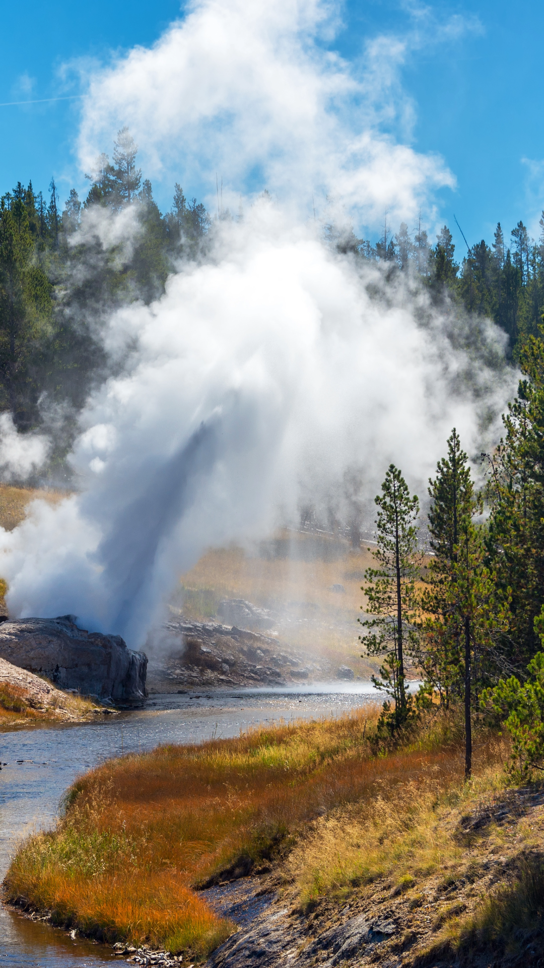 A geothermal feature spews steam at Grand Prismatic Pond in Yellowstone National Park.