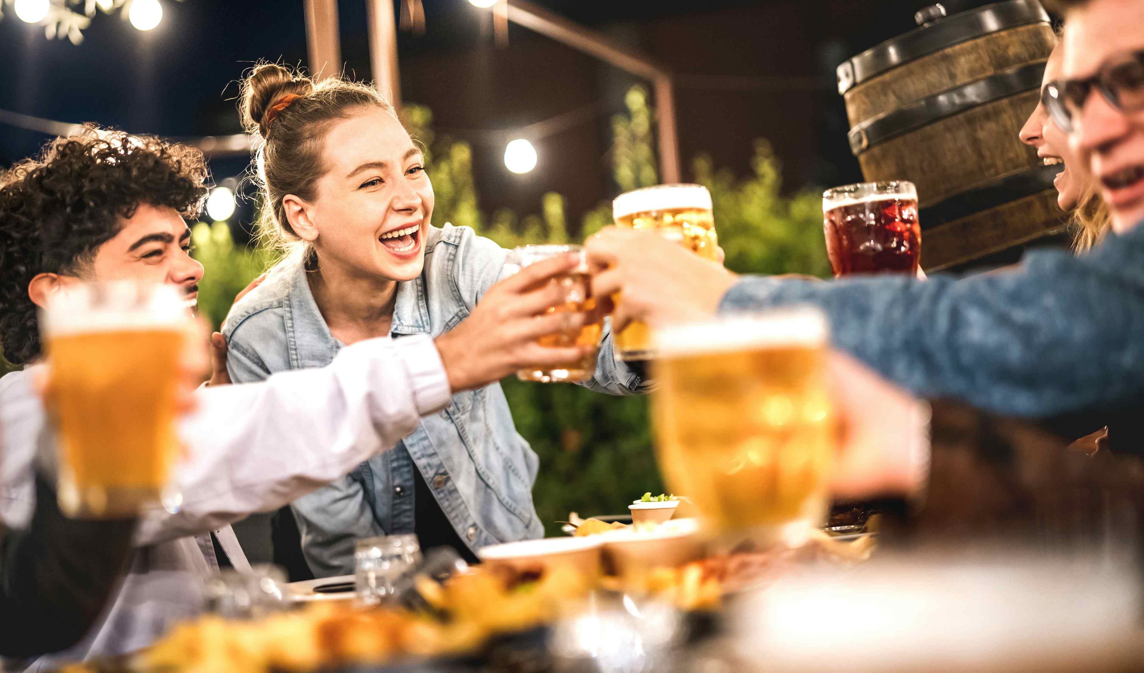 A group of friends toast with beer at a brewery in Idaho Falls, ID.