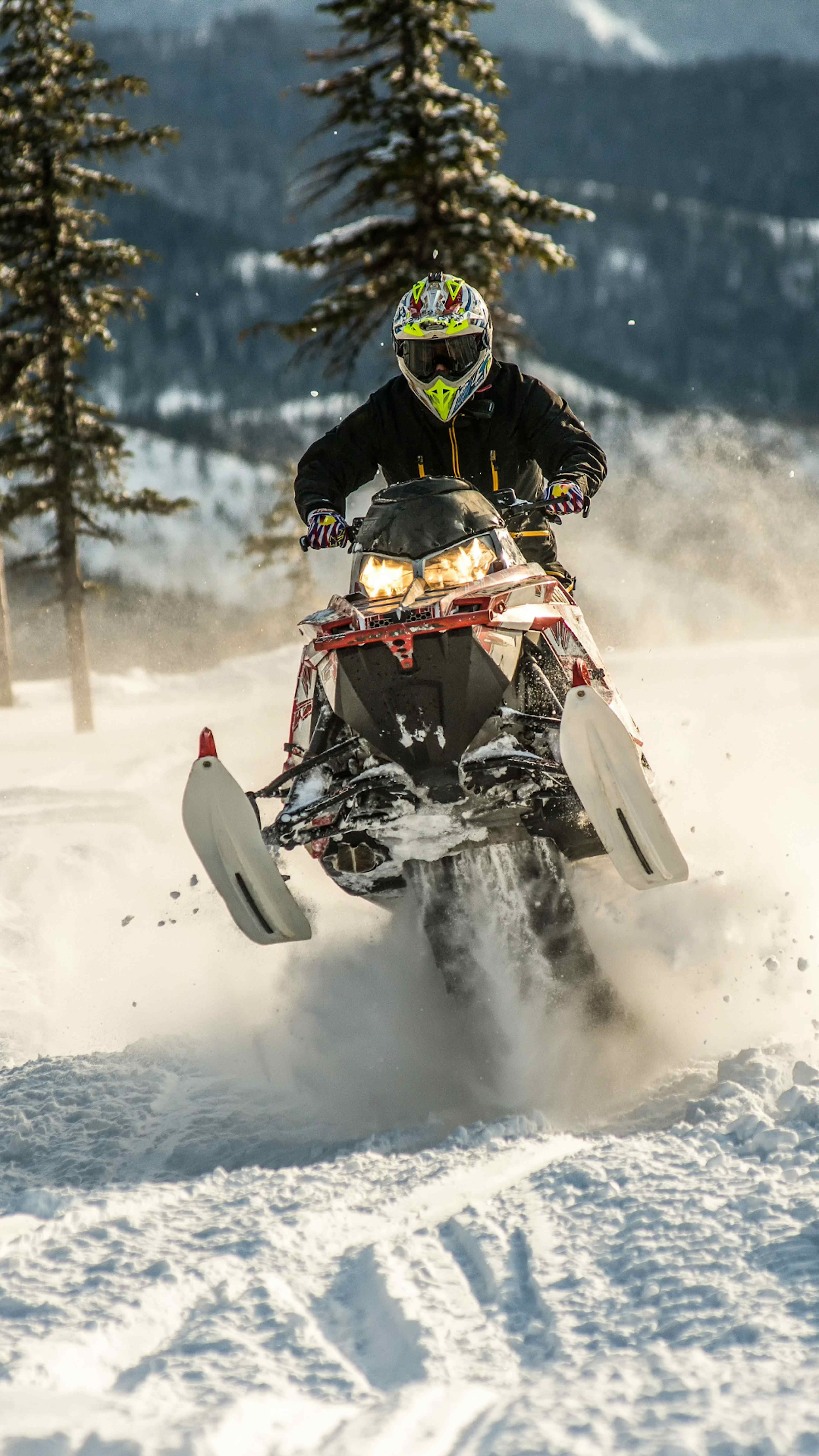 A snowmobiler jumps through deep snow in Eastern Idaho.