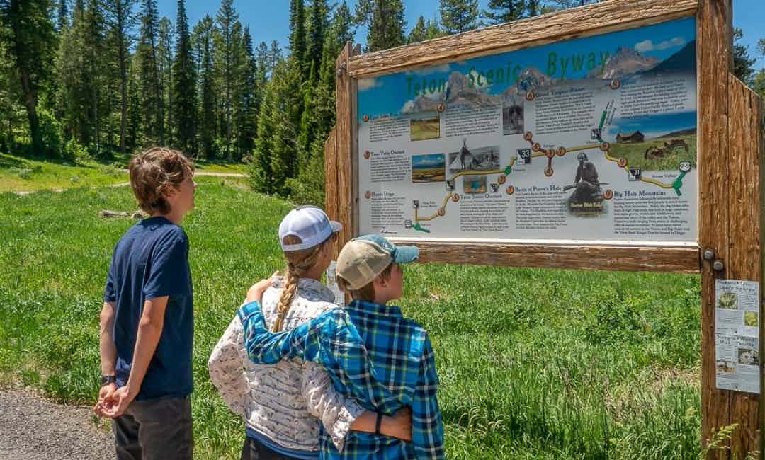 Looking at a marker of Teton Scenic Byway in Yellowstone Teton Territory.