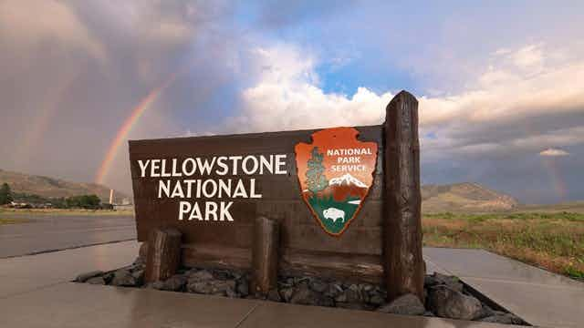 Sign at Yellowstone National Park entrance in Yellowstone Teton Territory.