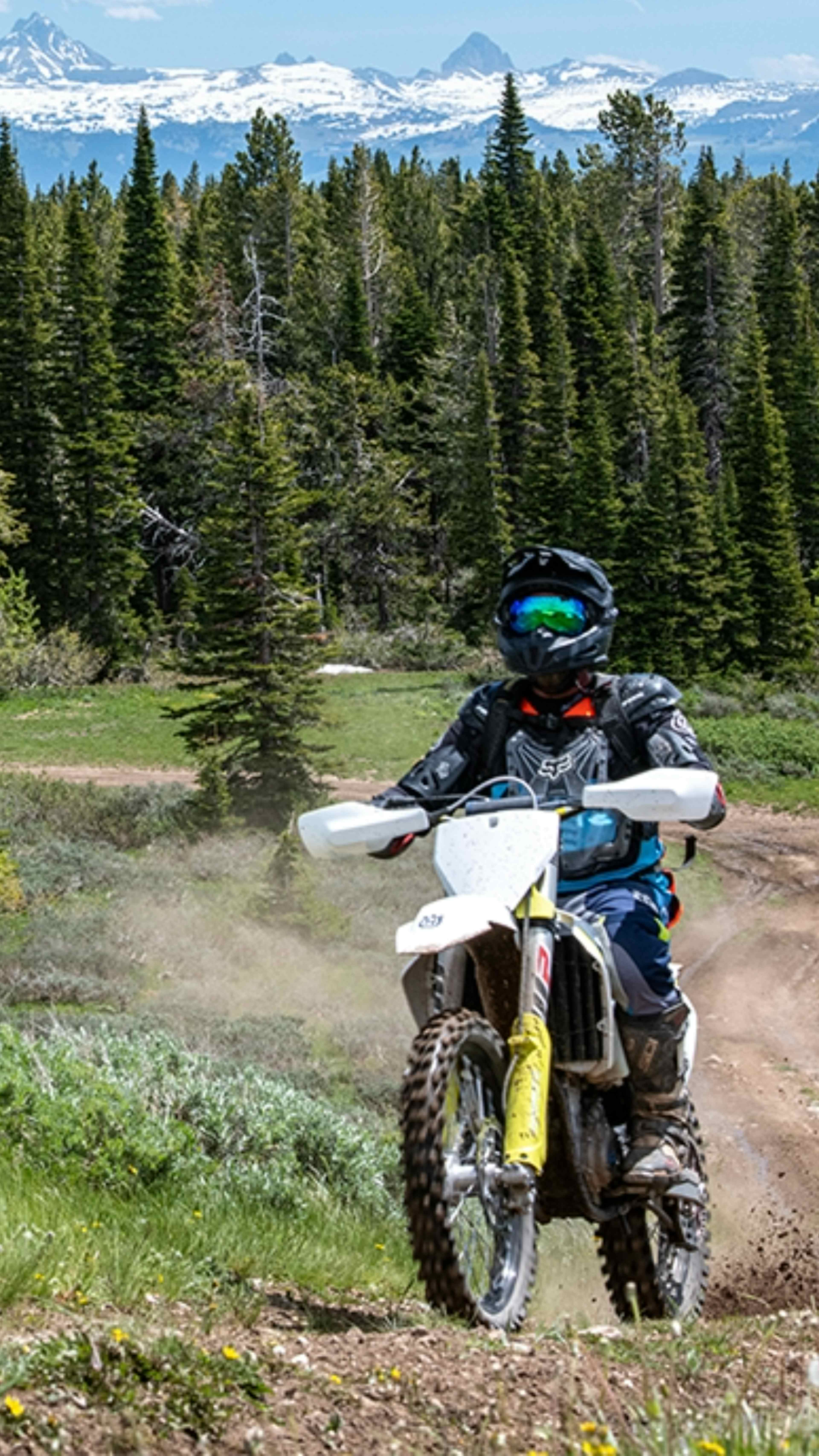 A dirt biker in the Big Holes in Teton Valley with a Teton Mountain Range as a backdrop.