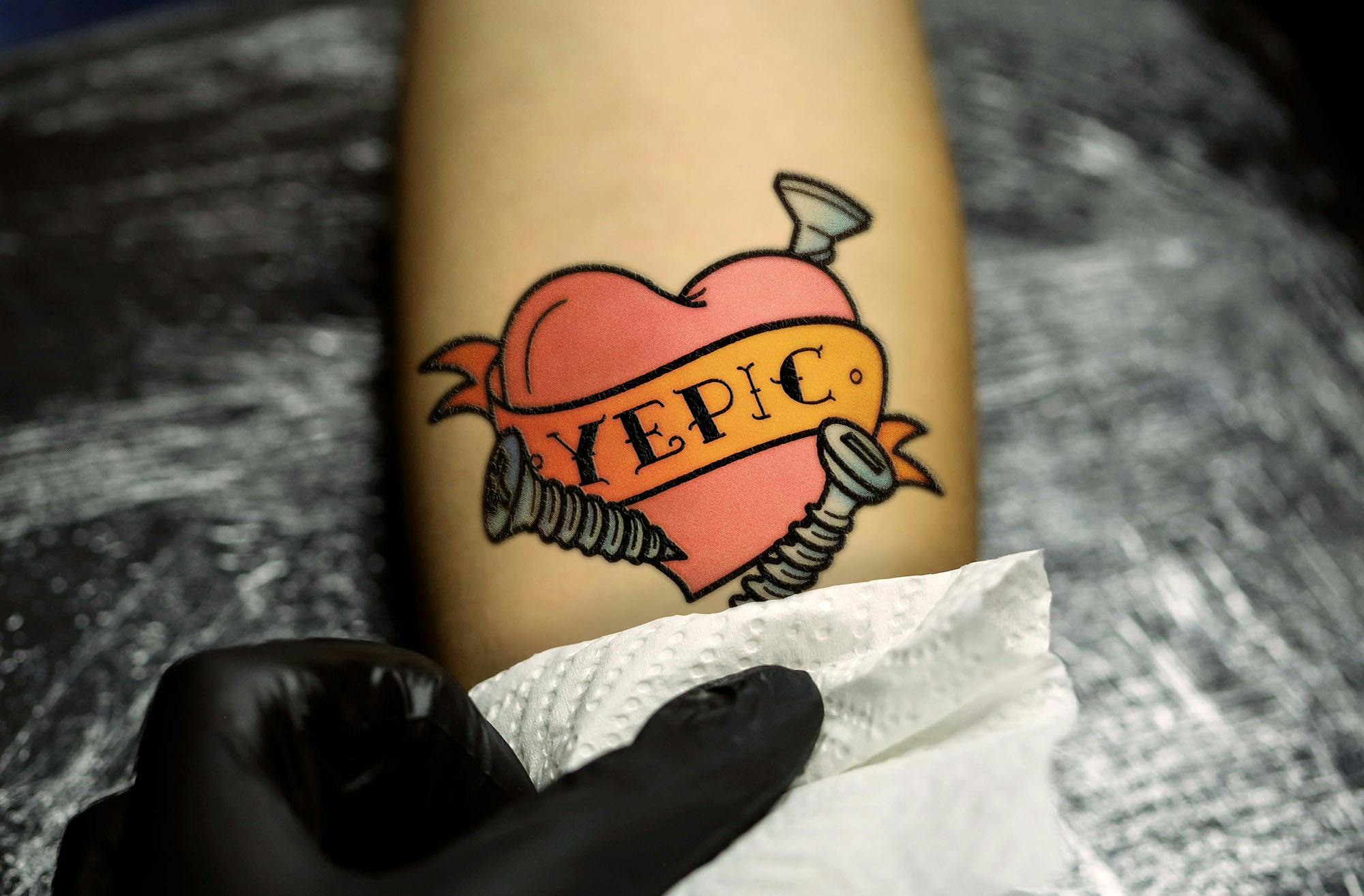 Yepic logo as a tattoo on forearm.