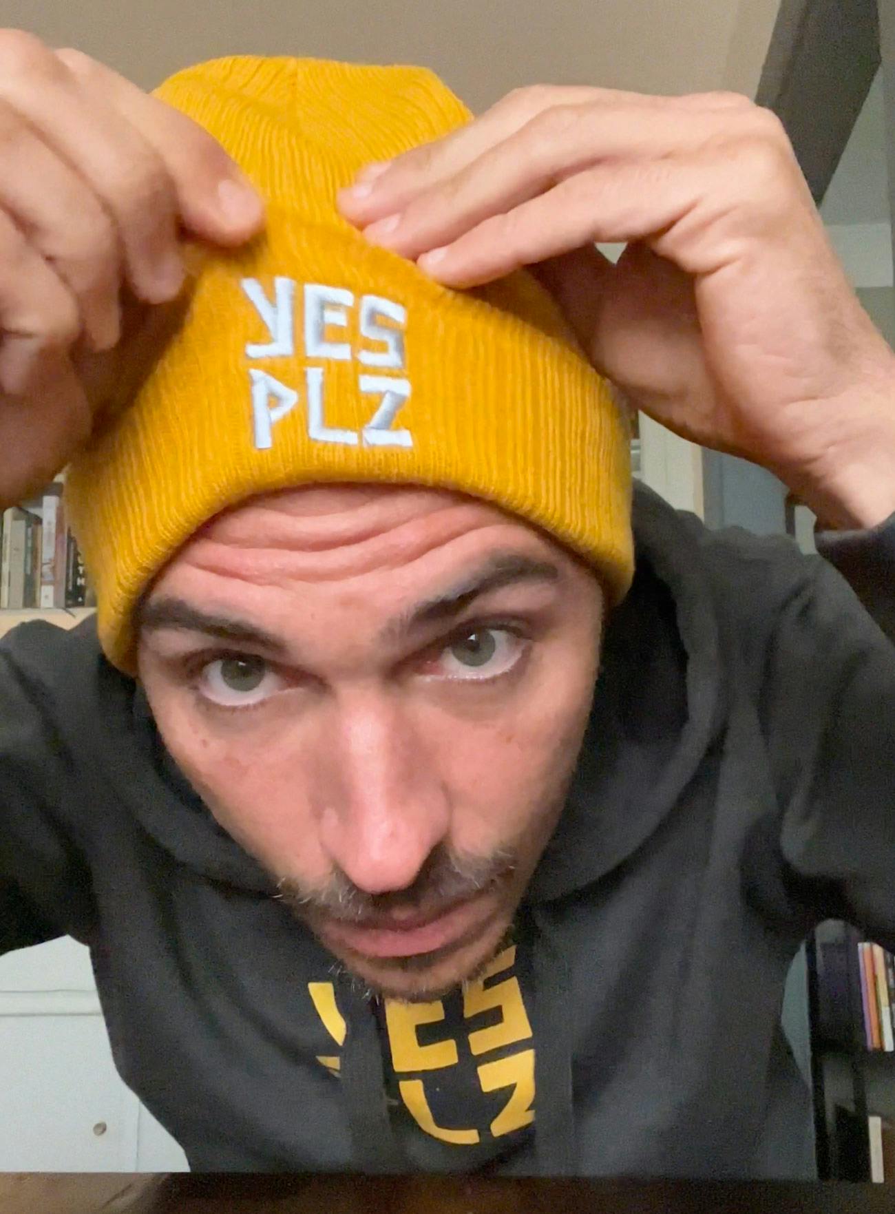 Devin sports the latest in high fashion--a YES PLZ Coffee hoodie and yellow beanie
