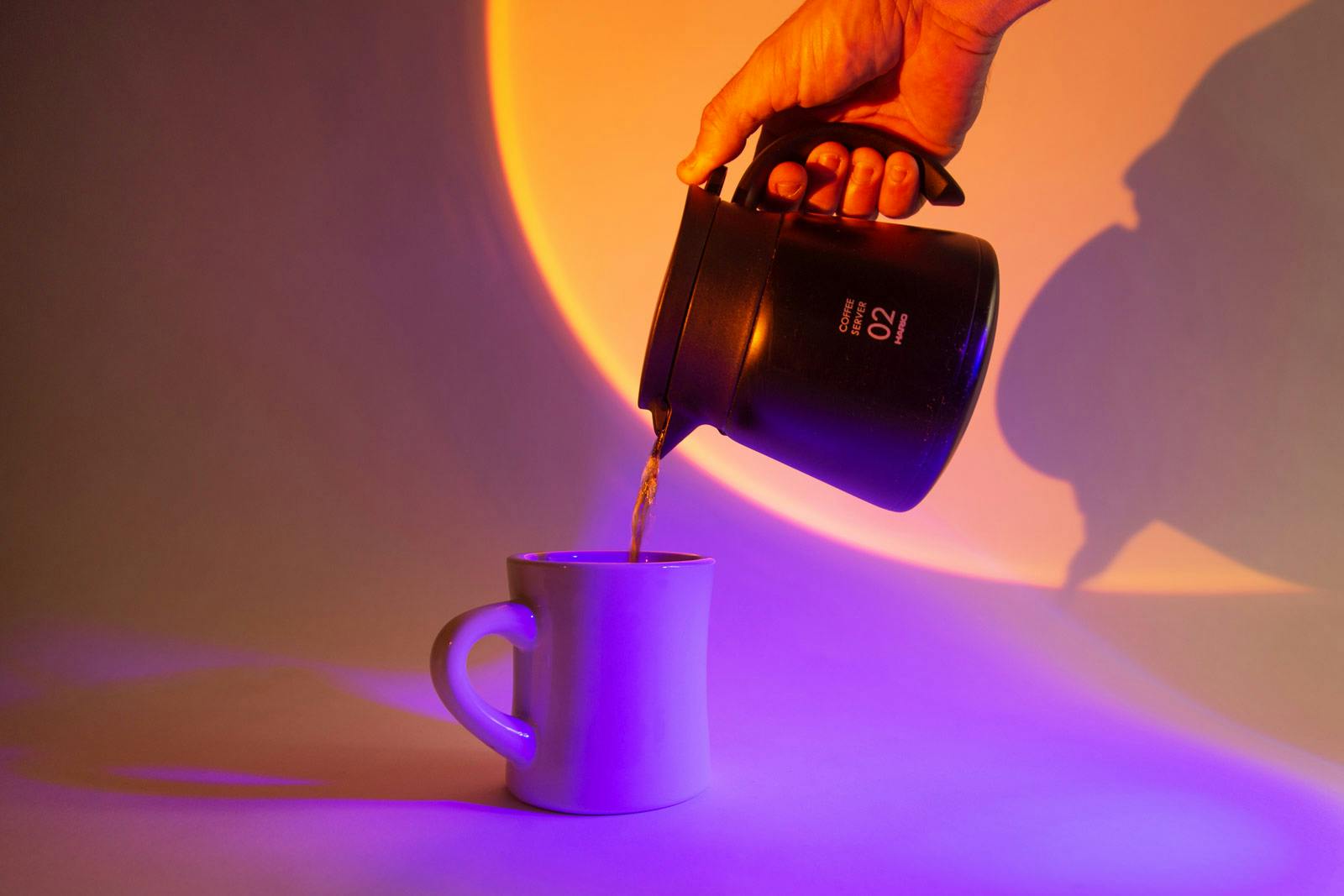 pouring coffee from a Hario insulated carafe