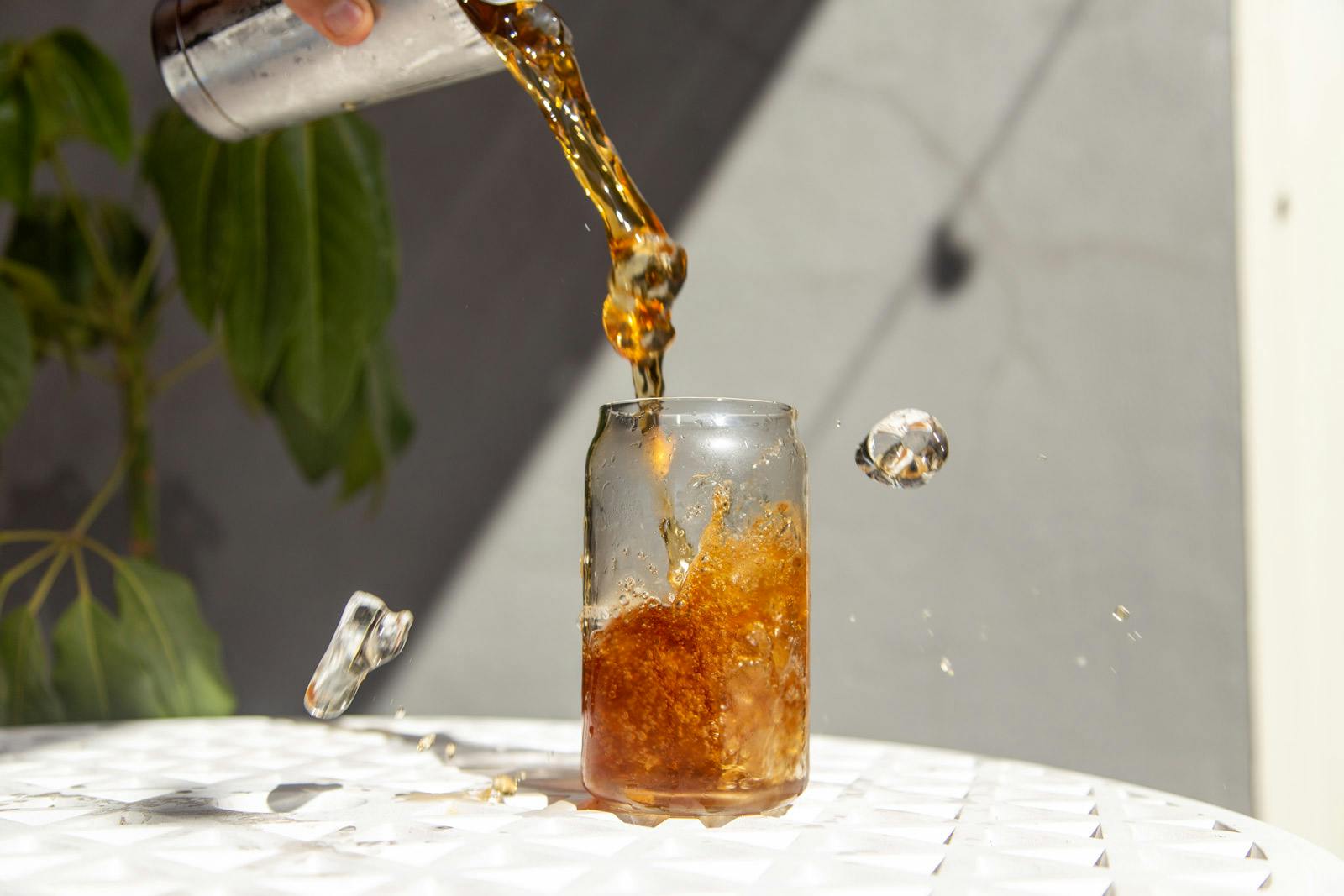 pouring some homemade cold coffee on a hot summer day