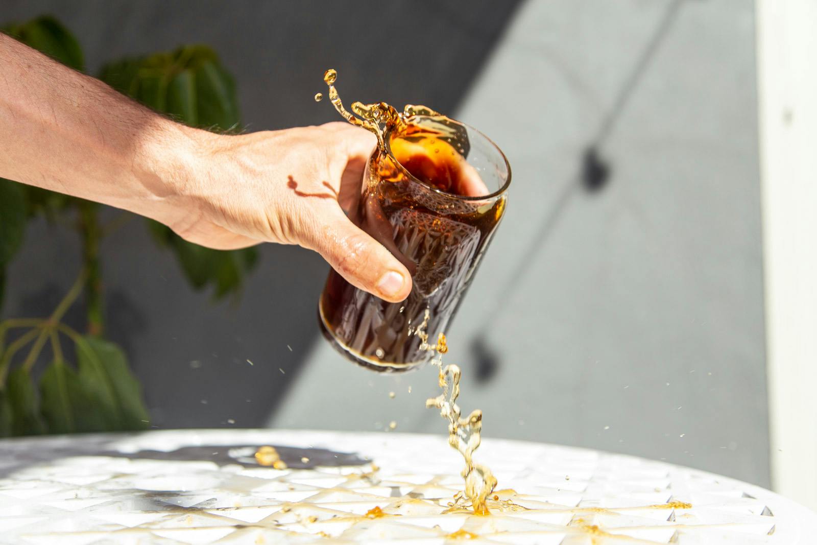 splashes from a glass of iced coffee on a sunny summer day