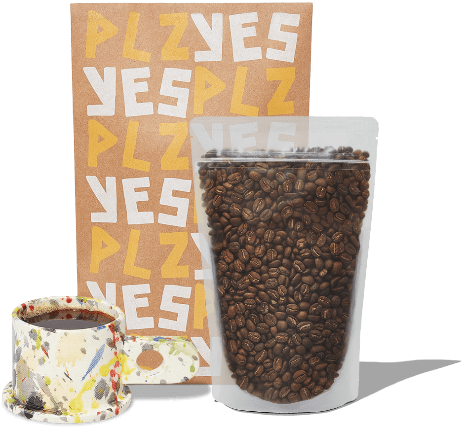 A photograph of our bag of coffee with the packaging behind it and a fresh cup of brewed hot coffee in a unique mug.