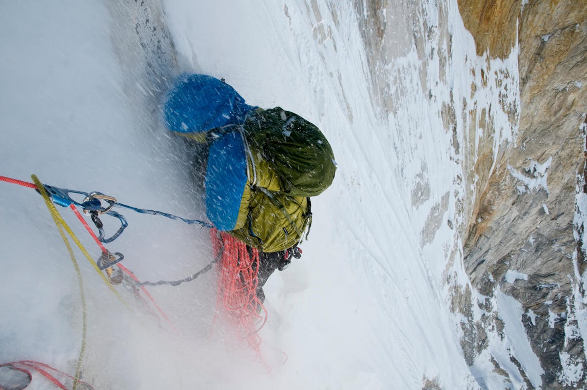 Renan Ozturk sheltering from sluff while climbing