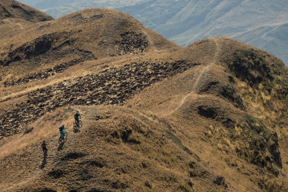 Carston Oliver, Nate Hill, and Joey Schusler riding a ridge