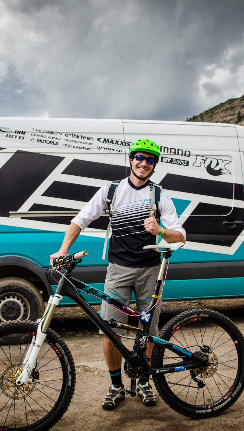 Gathering member posing in front of a Yeti van