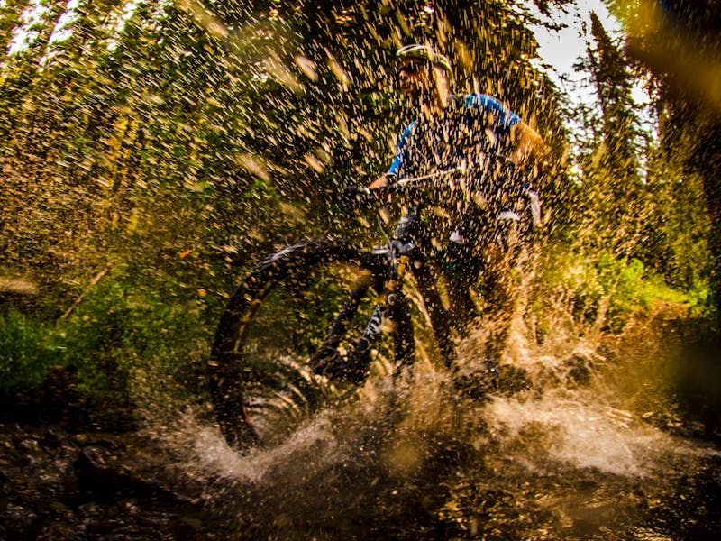 Rider splashing through a puddle