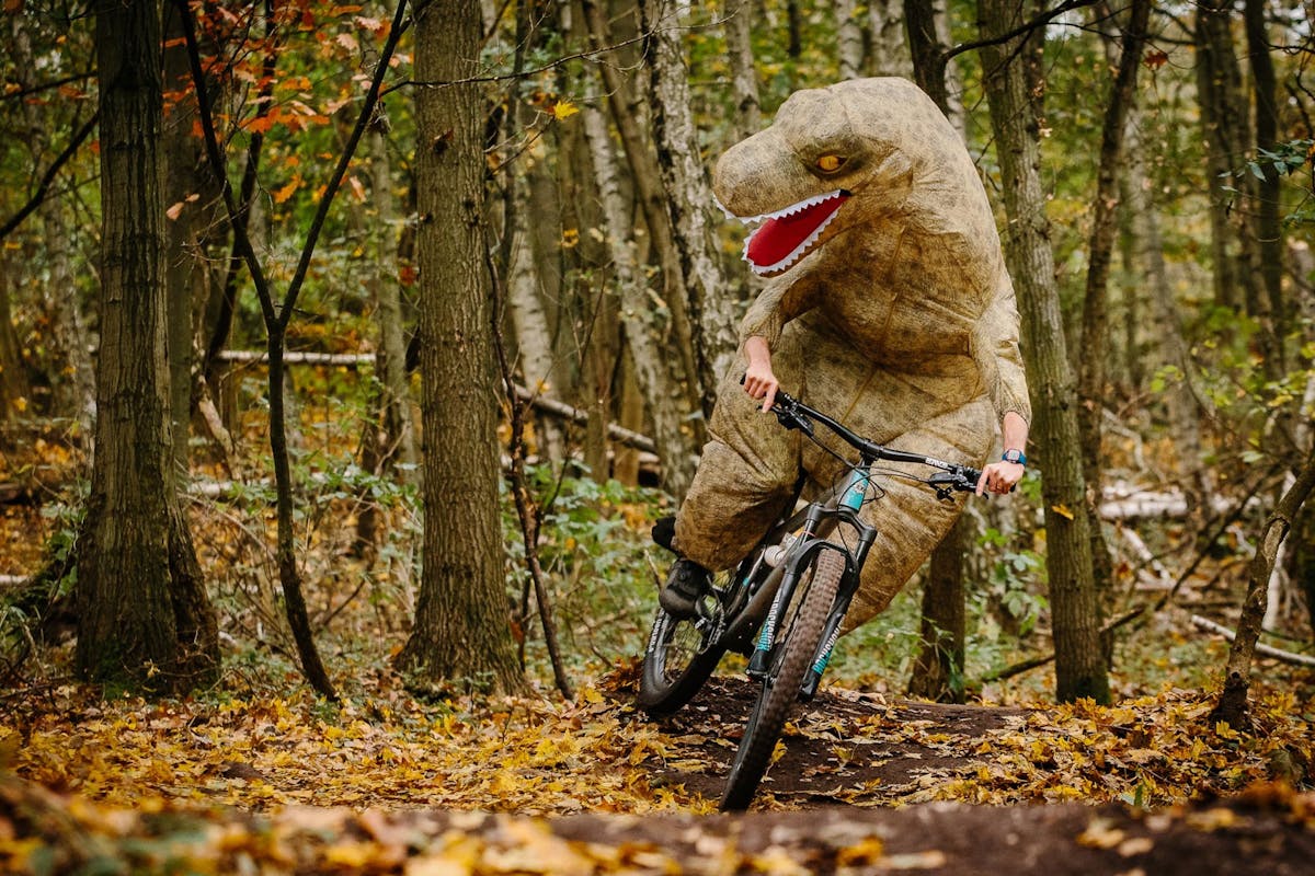 Lee Trumpore wearing a dinosaur costume while doing a skid