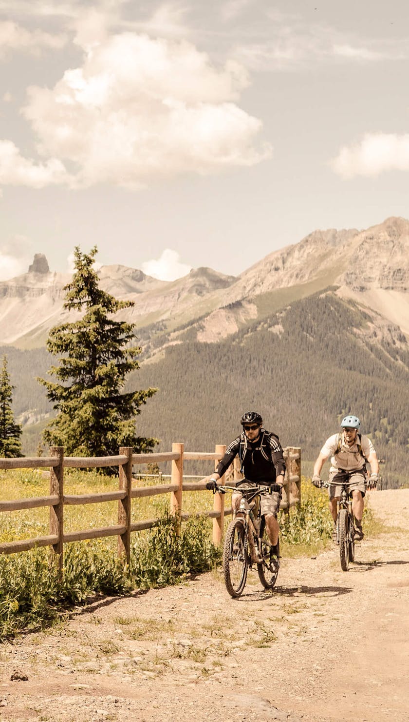 Riders passing an older structure