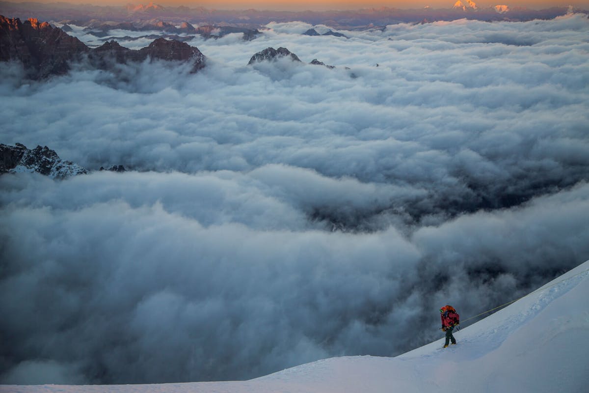 Renan Ozturk climbing above the clouds