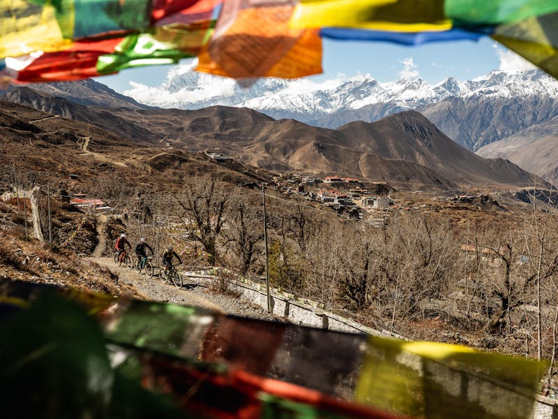 International Gathering Nepal - Three riders riding though town