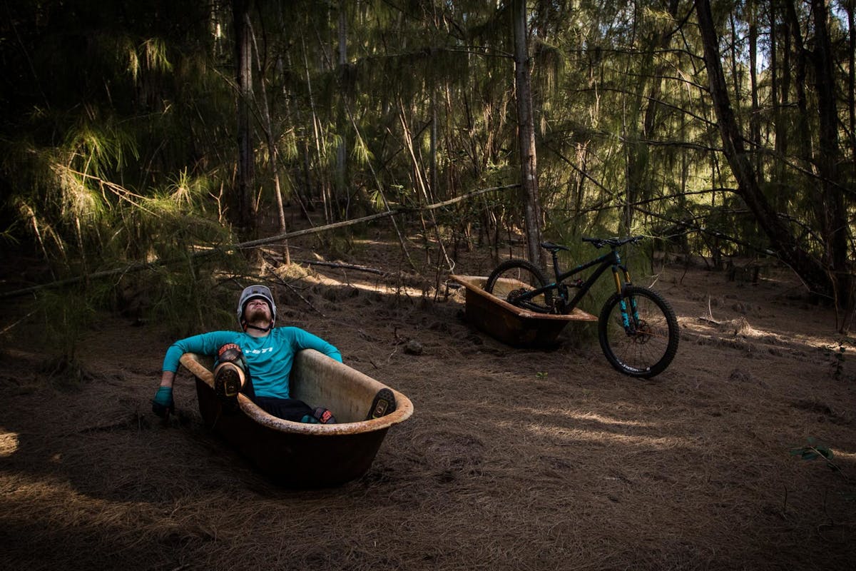 Max Fierek resting in a trailside bathtub
