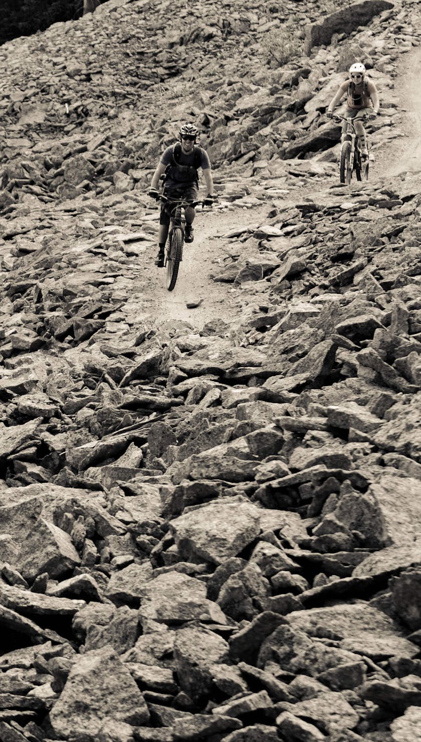 Riders crossing a scree field 