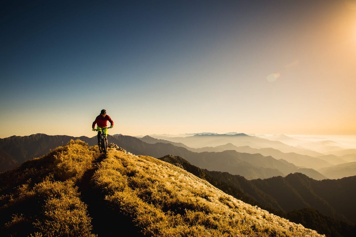 Lee Trumpore riding a ridgeline at sunset