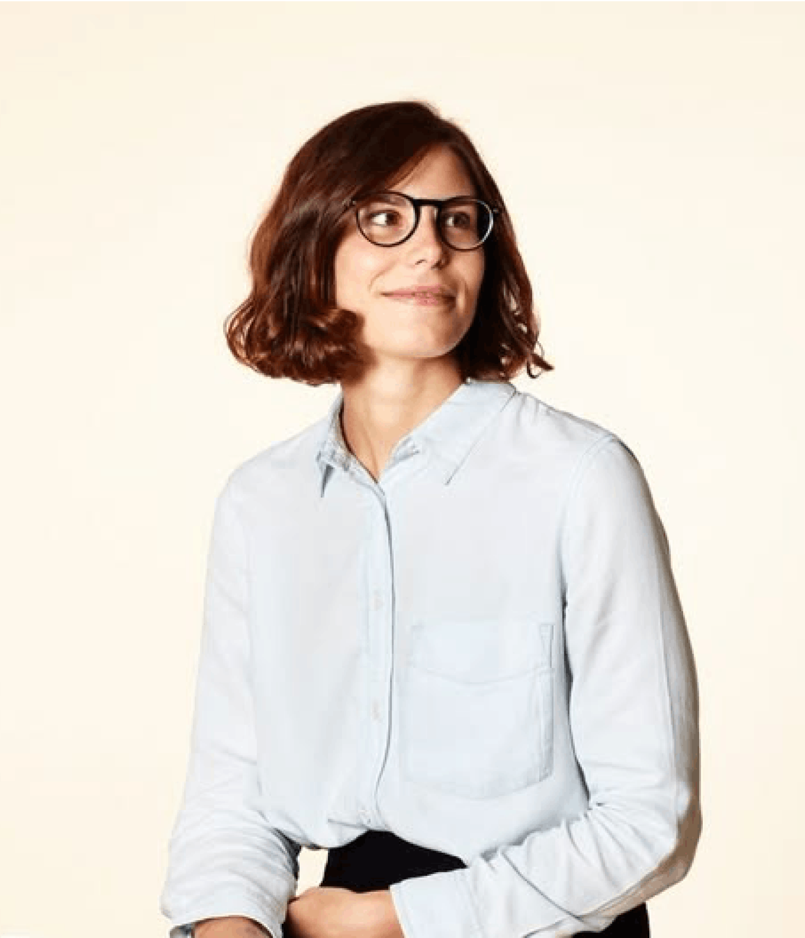 Woman standing in front of a beige background