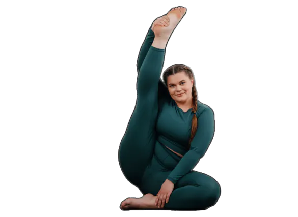 A woman in teal leggings and a long-sleeve shirt sits in a yoga pose, holding one foot high in the air. The image resolution is 4096x2730 pixels.