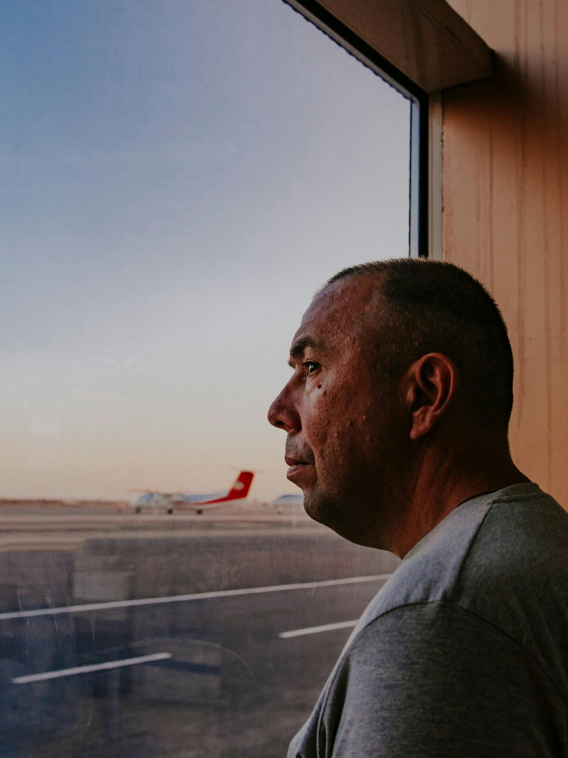 A man looks out of an airport window