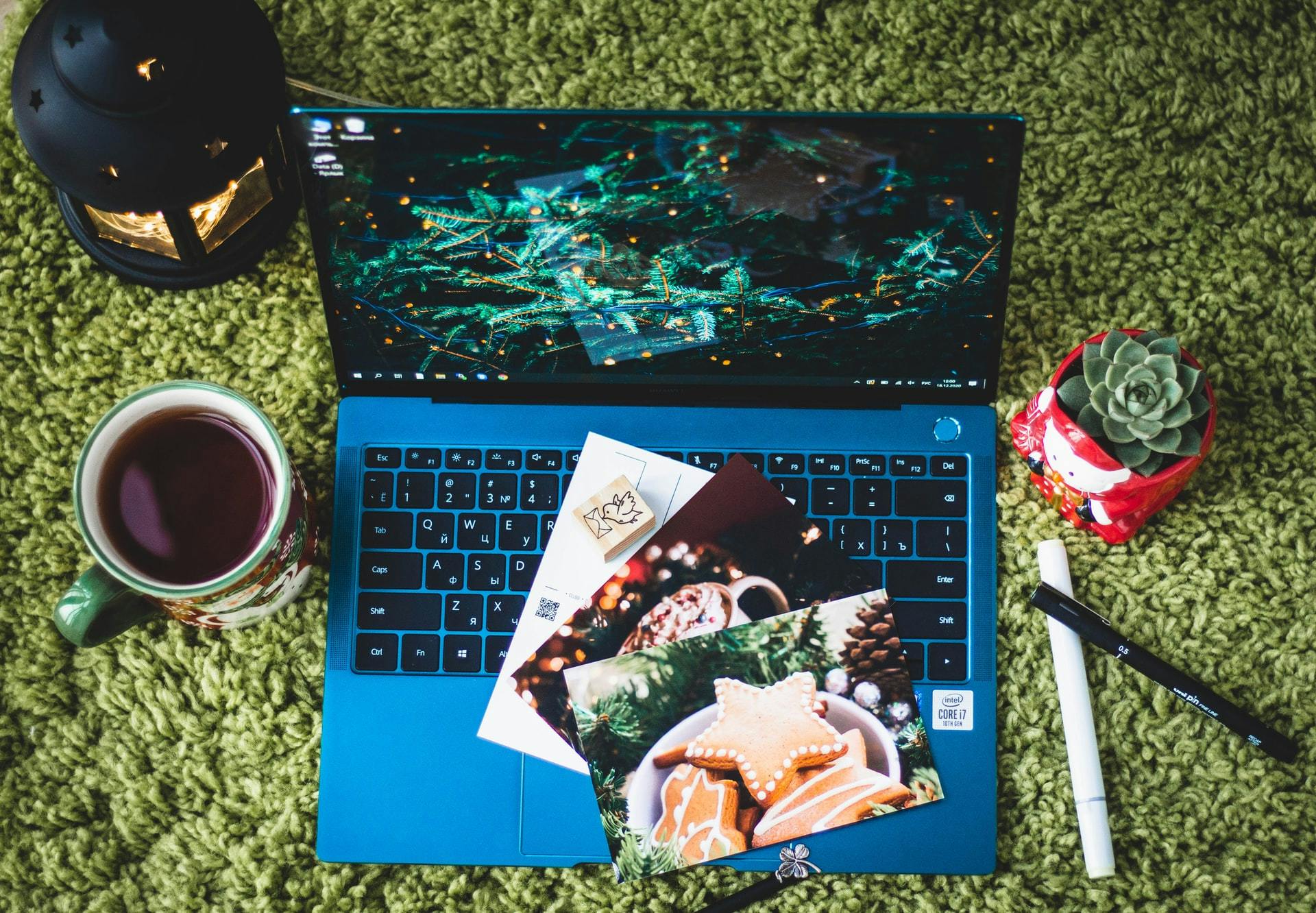 A collection of postcards on top of a blue laptop