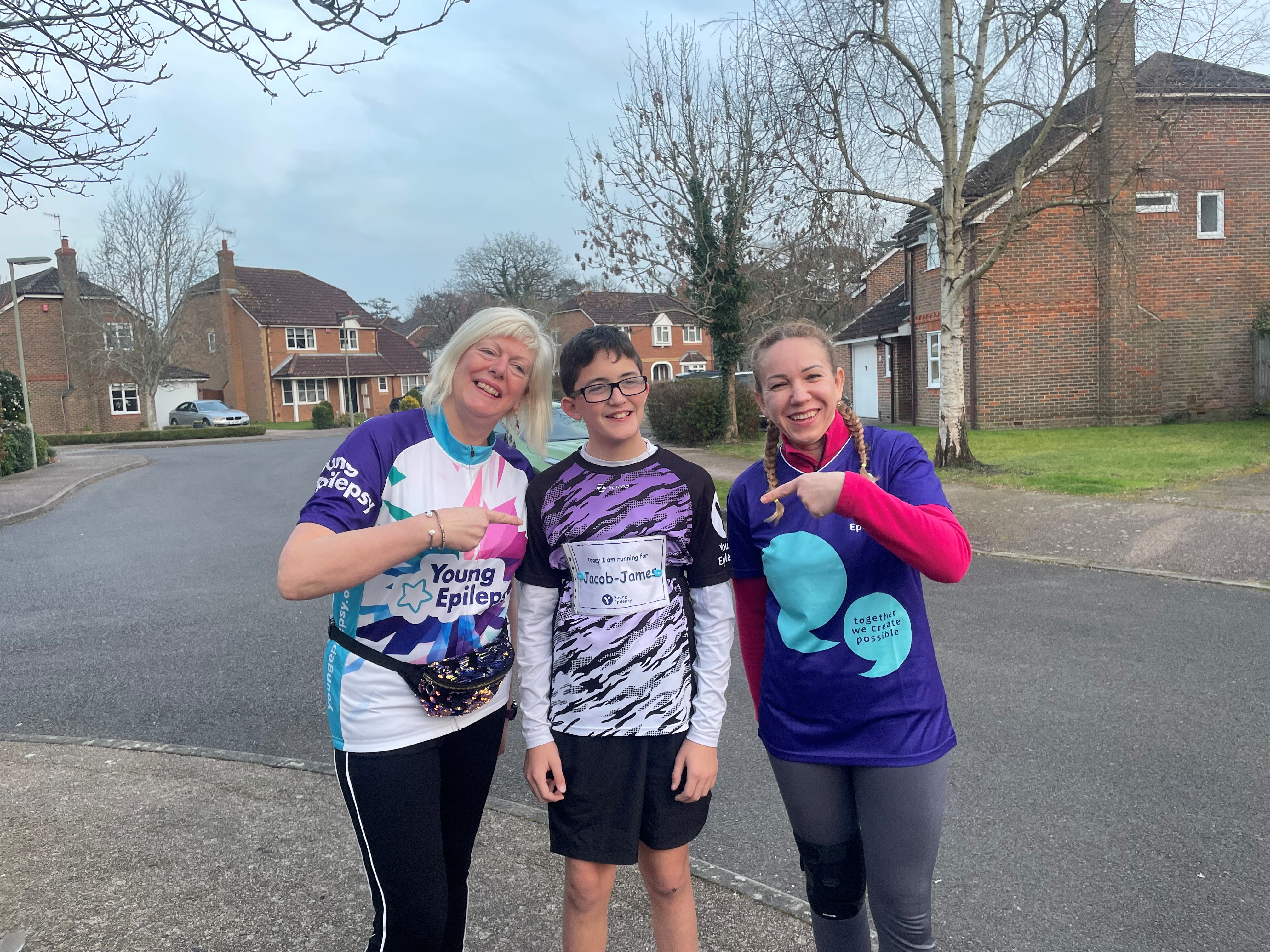 Zac, Lorraine and another friend smiling in their Young Epilepsy marathon tops. 