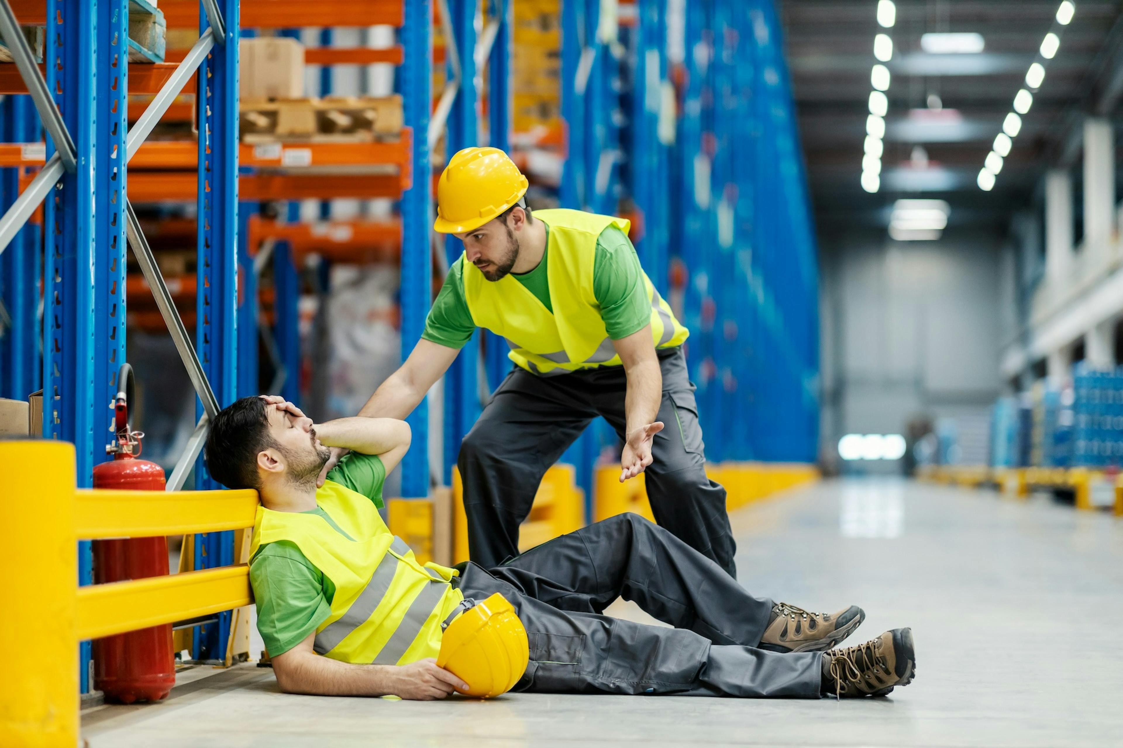 worker helping their injured colleague