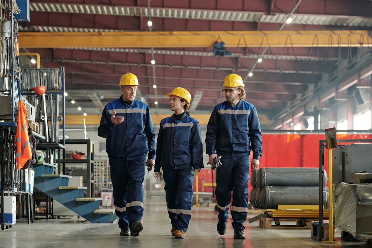 three workers walking through the warehouse