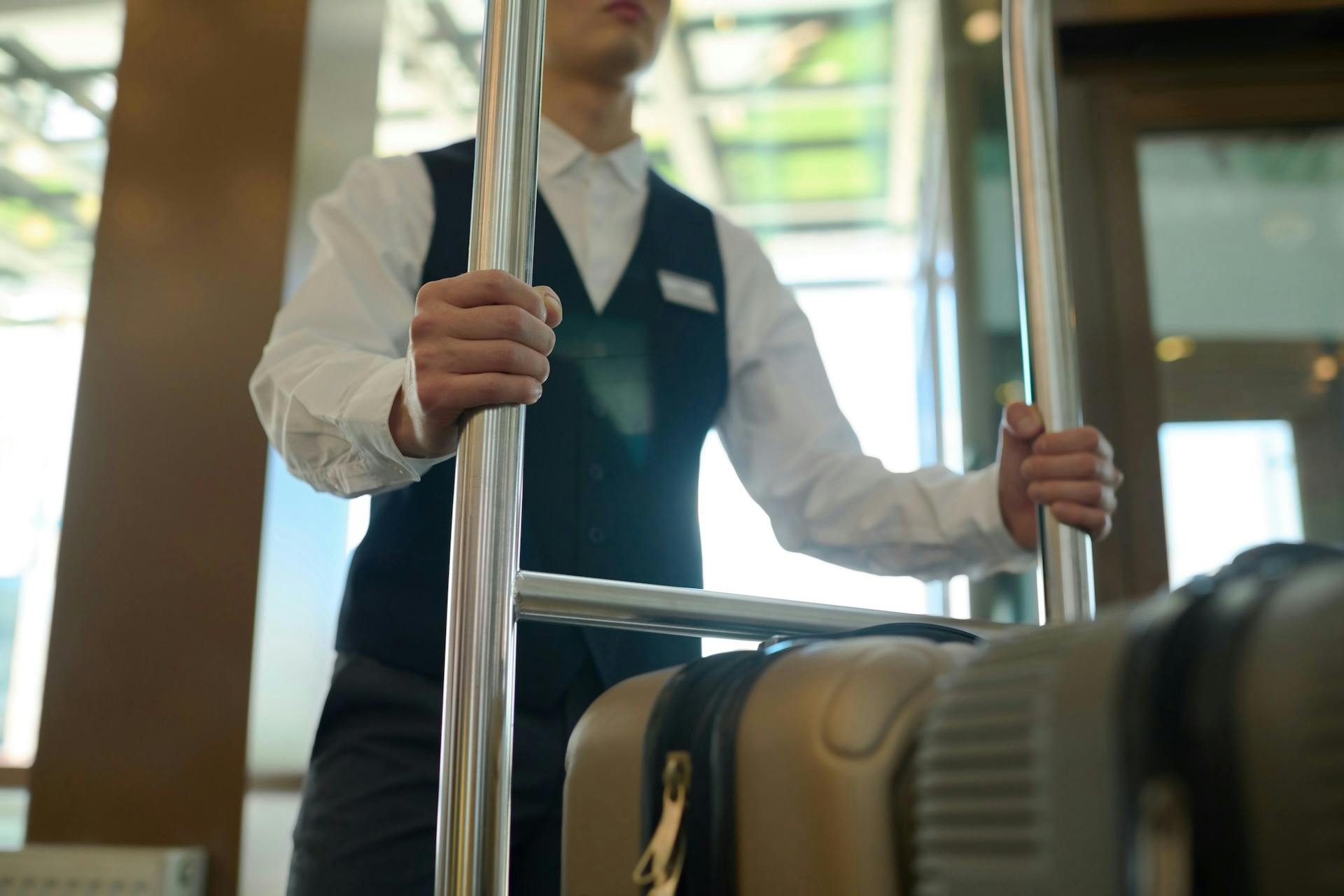 a hospitality worker pushing a trolley