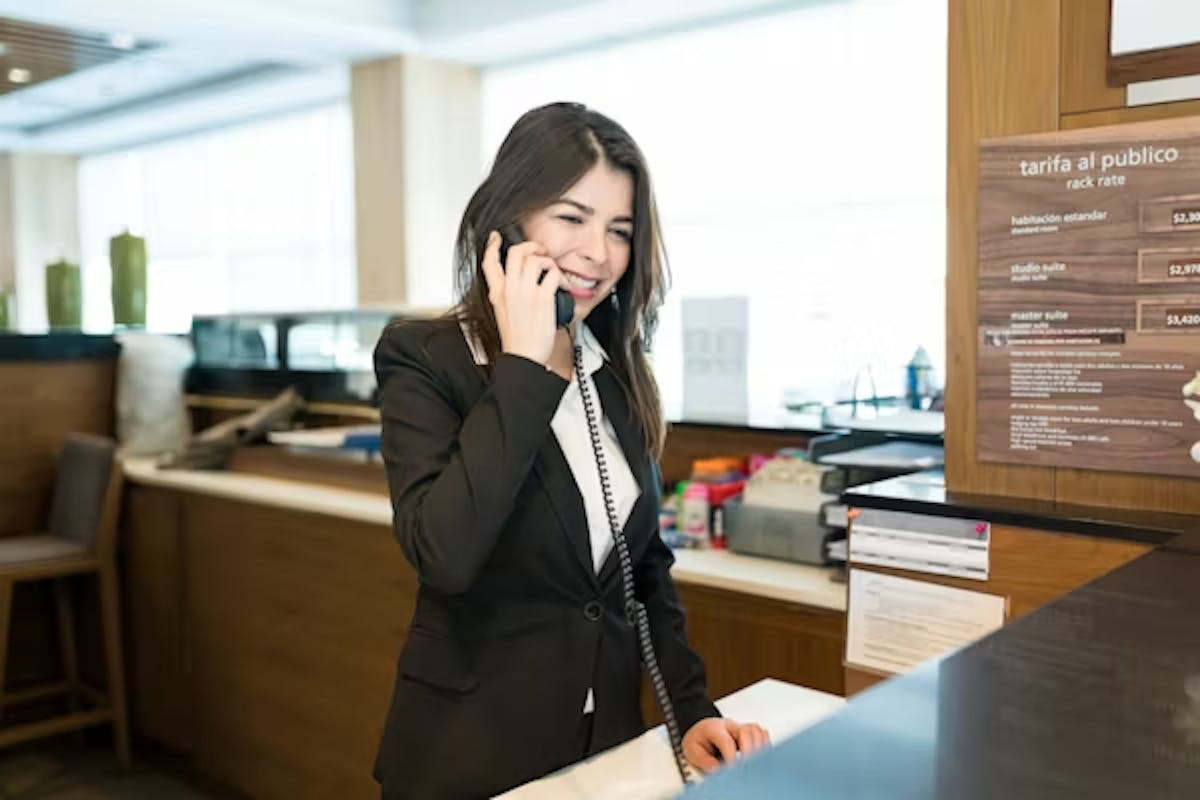 smiling female hospitality employee on phone