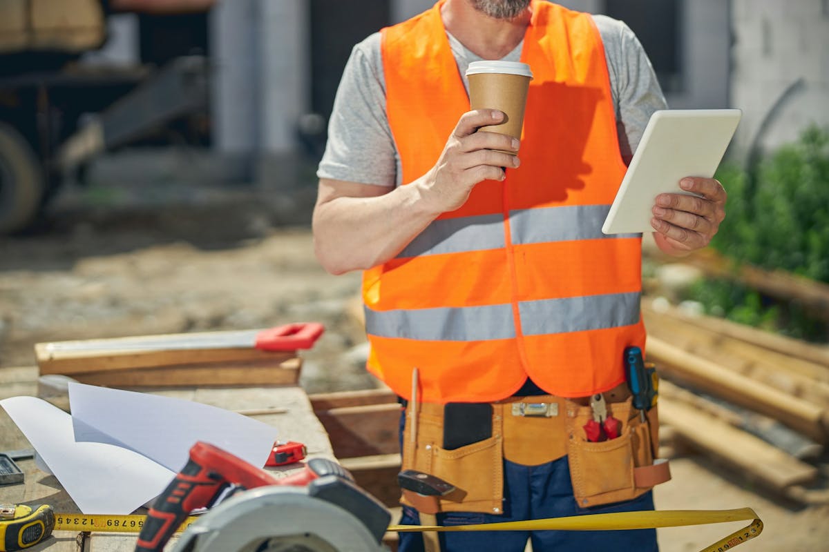worker holding a plastic cup