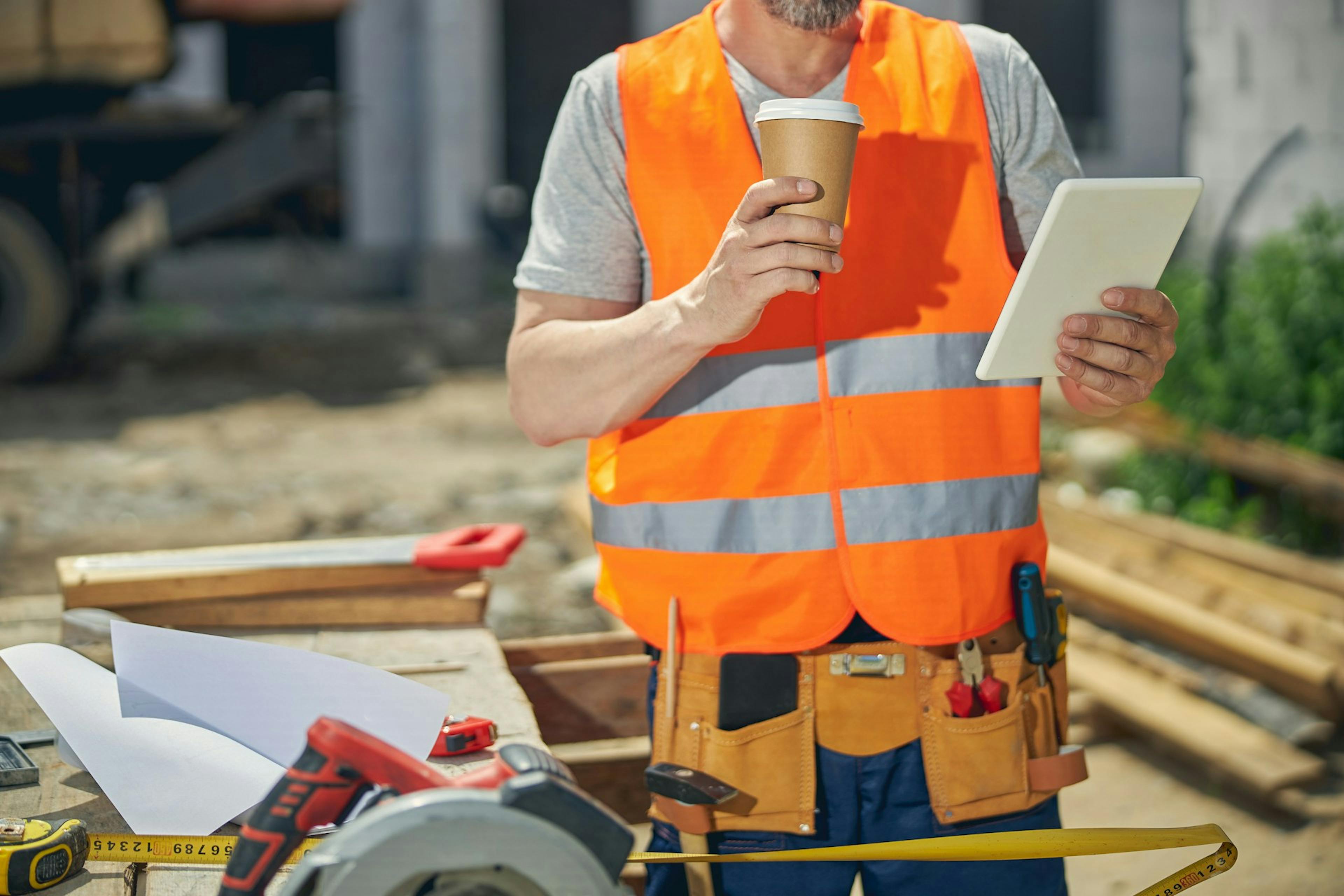 worker holding a plastic cup