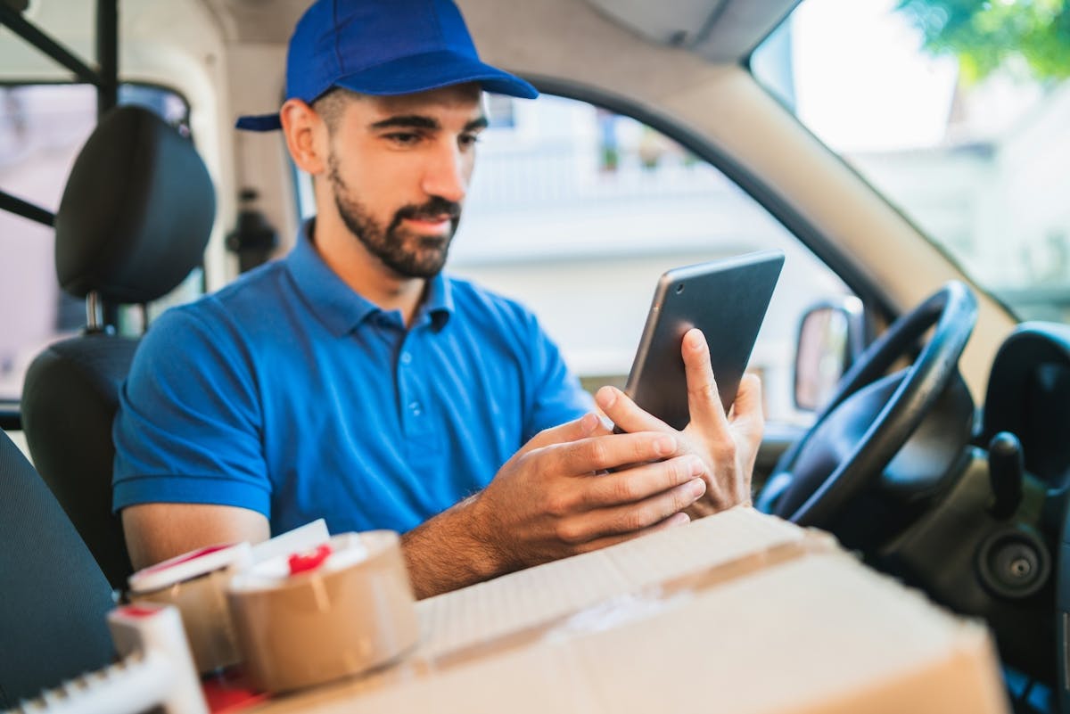 delivery worker looking at the screen