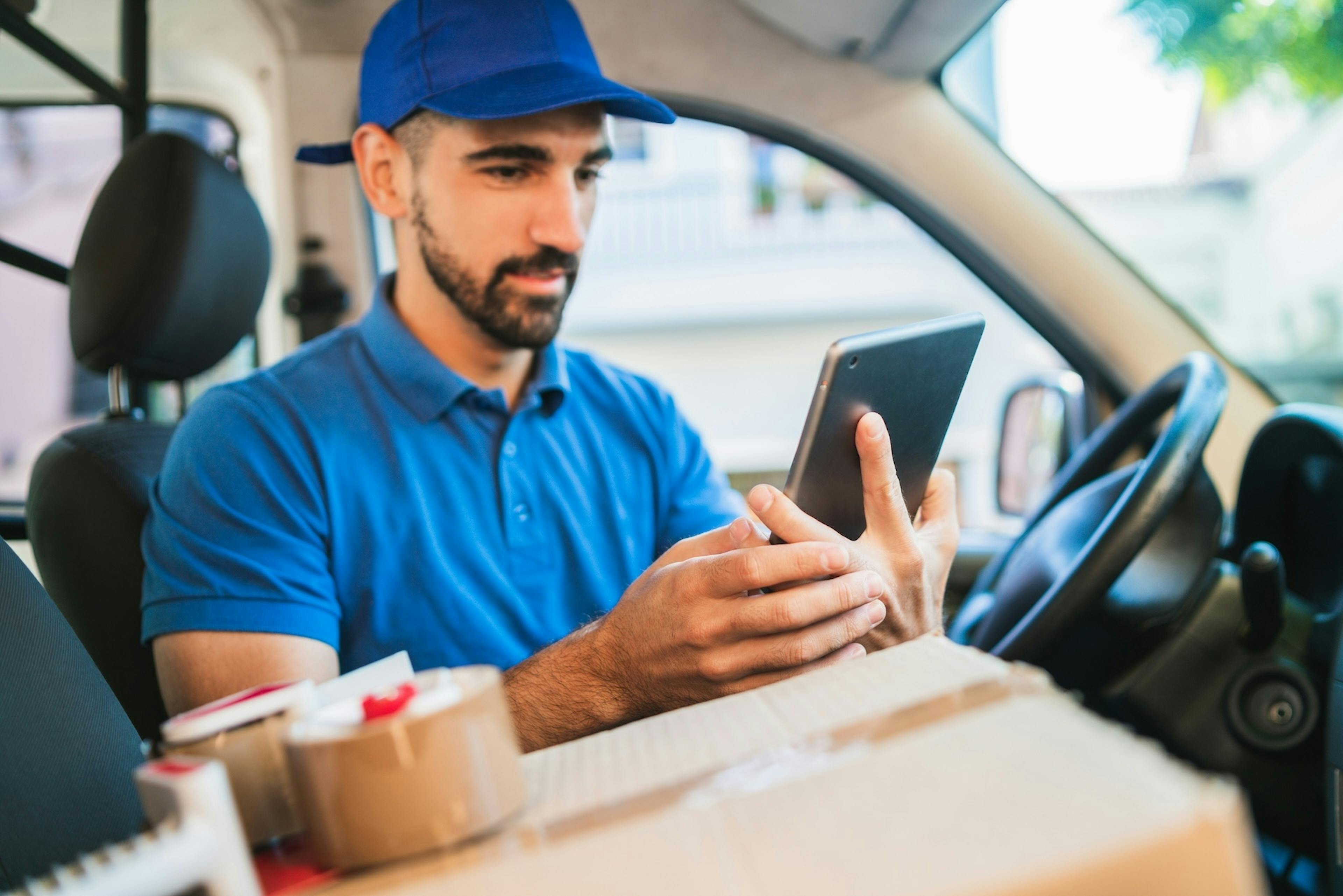delivery worker looking at the screen