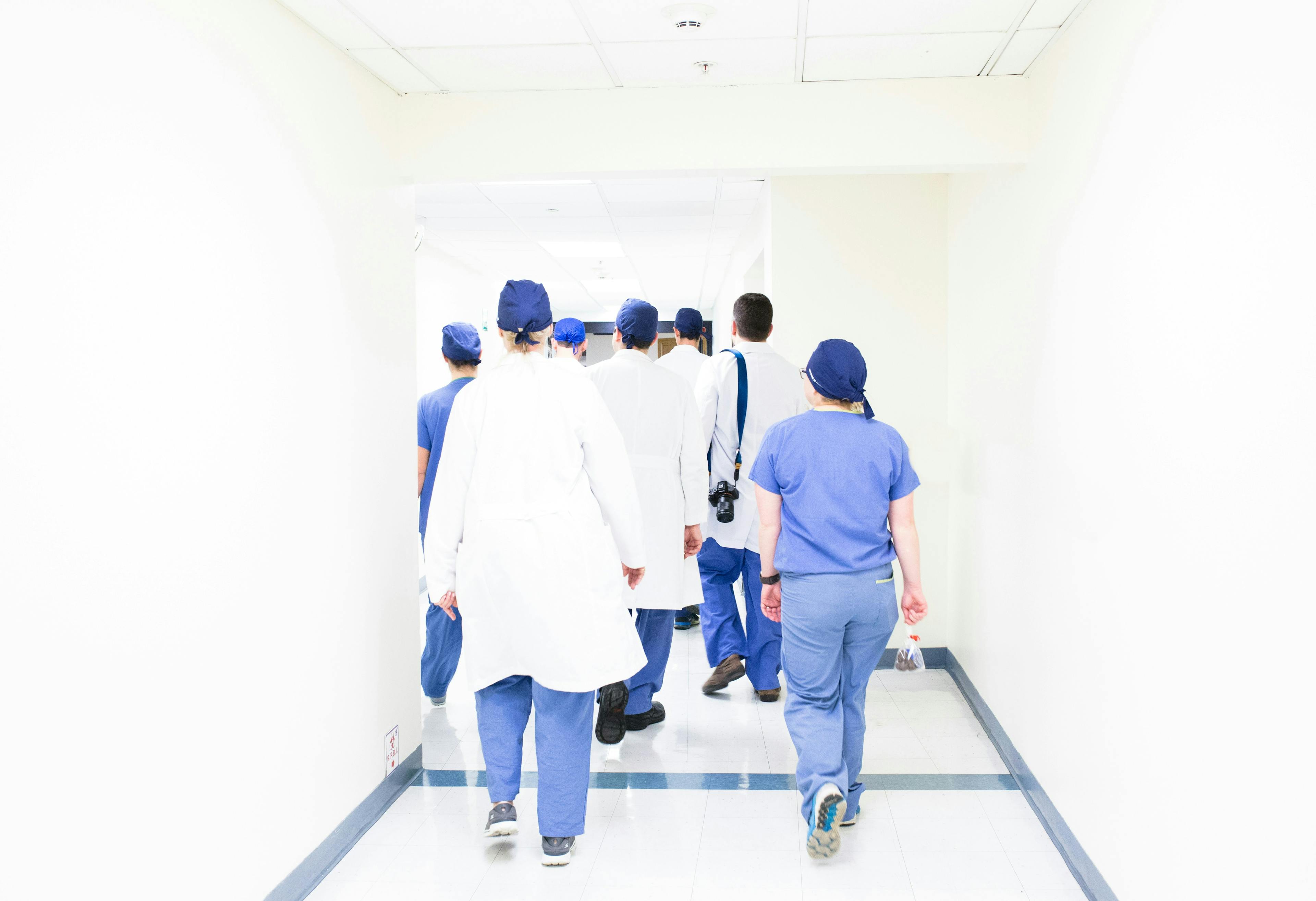 Healthcare workers walking through a hospital corridor
