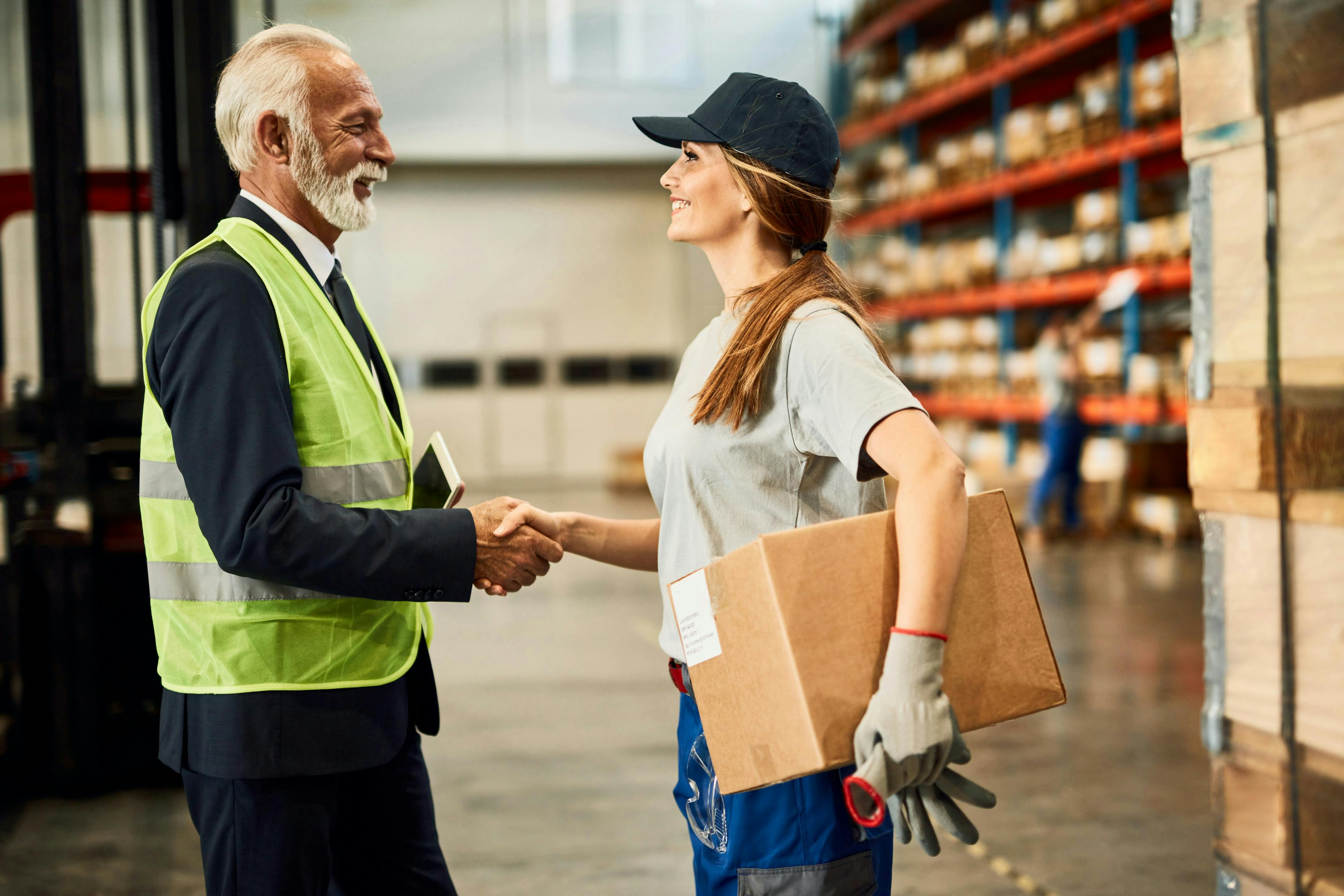 Manager welcoming new warehouse employee