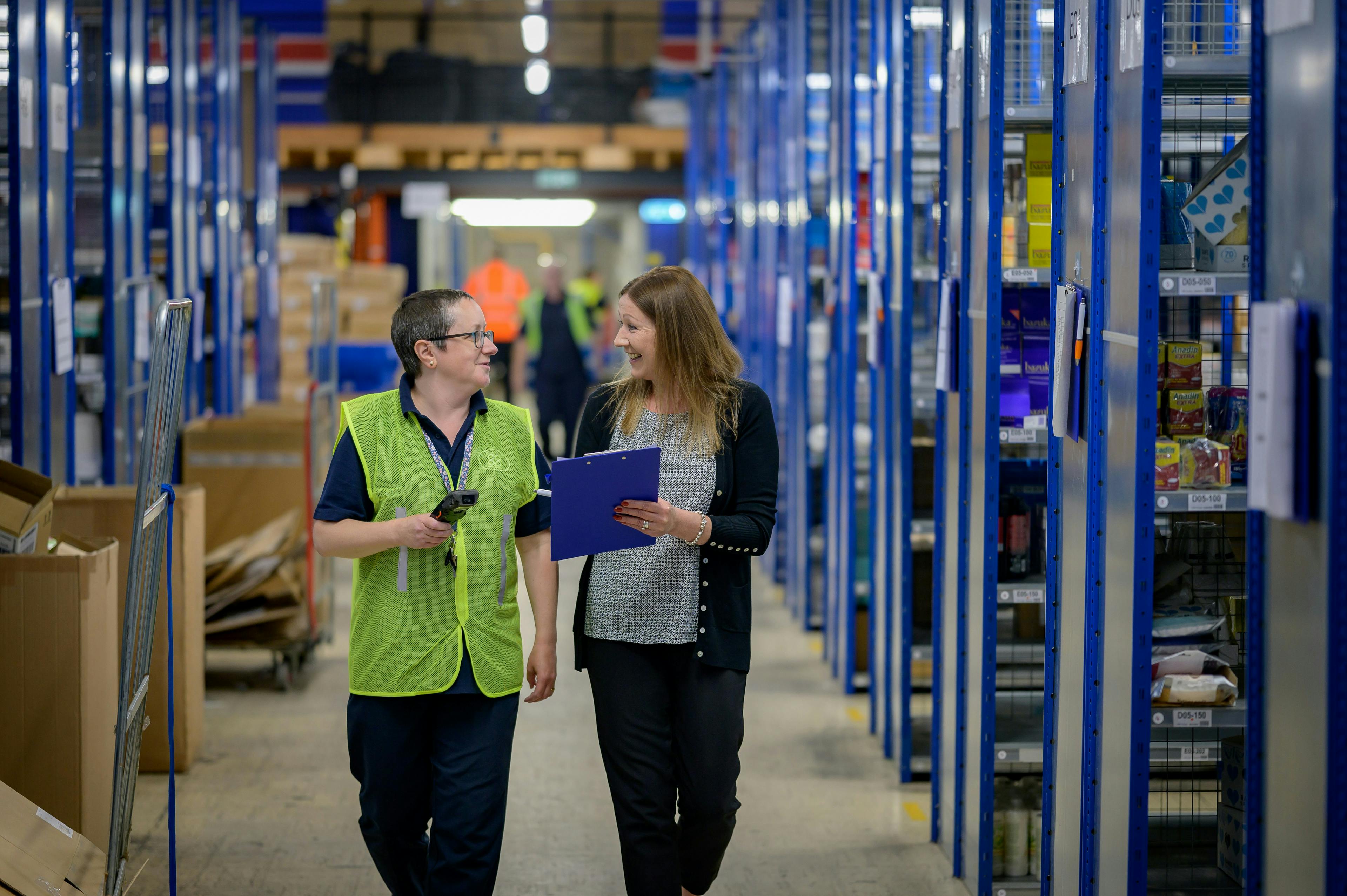 Manager and warehouse worker in conversation