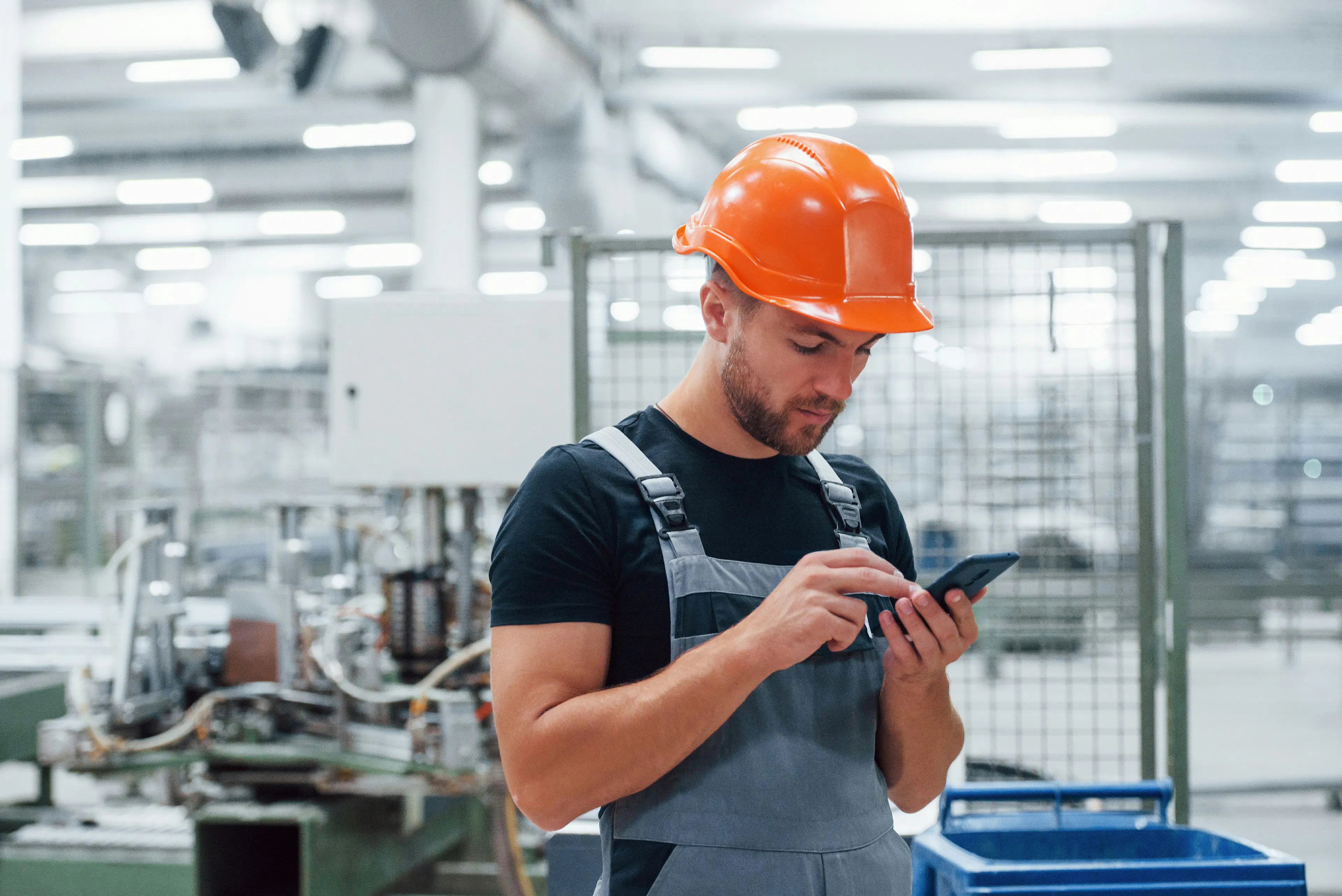 Factory worker checking phone
