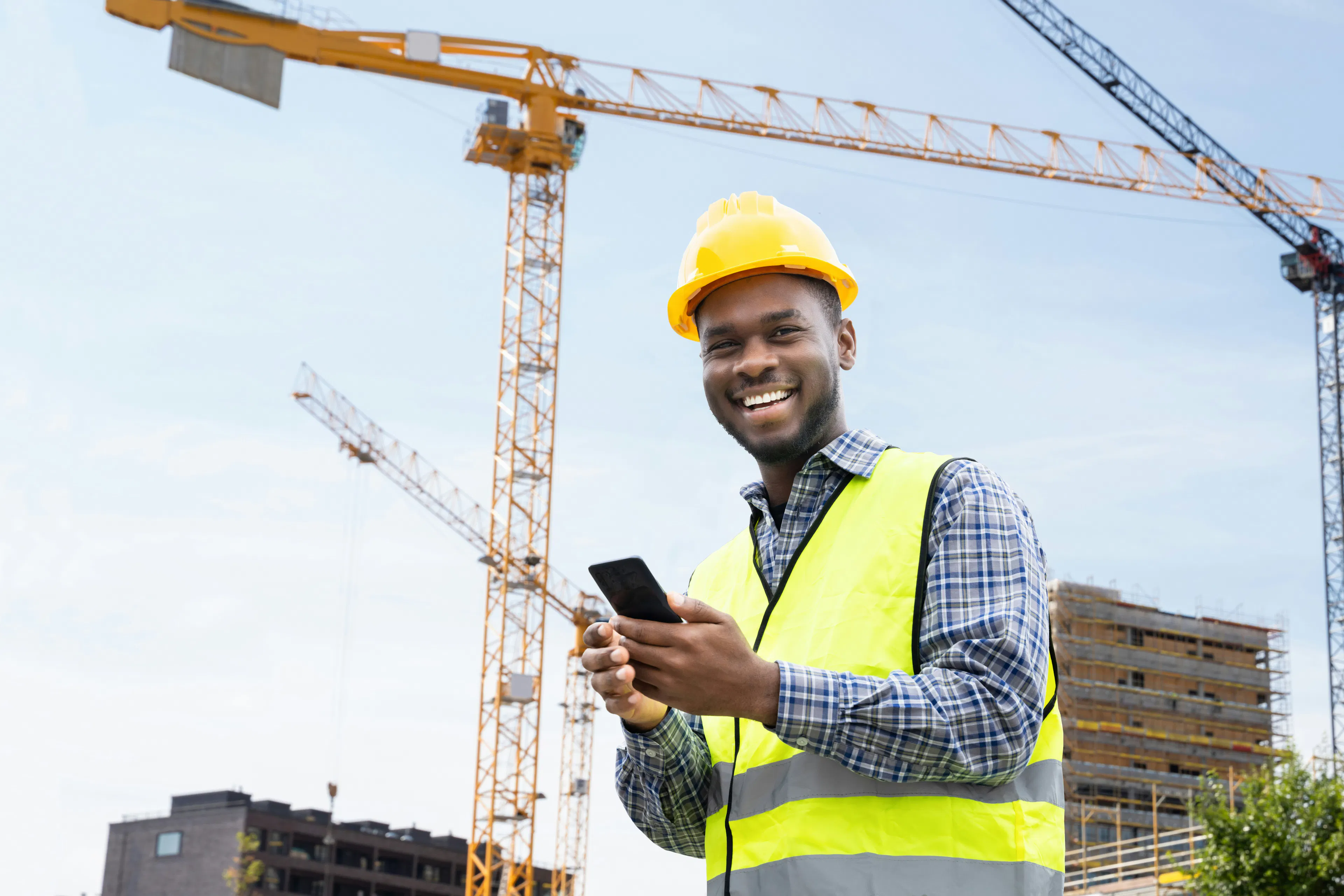 Construction worker using smartphone on job site