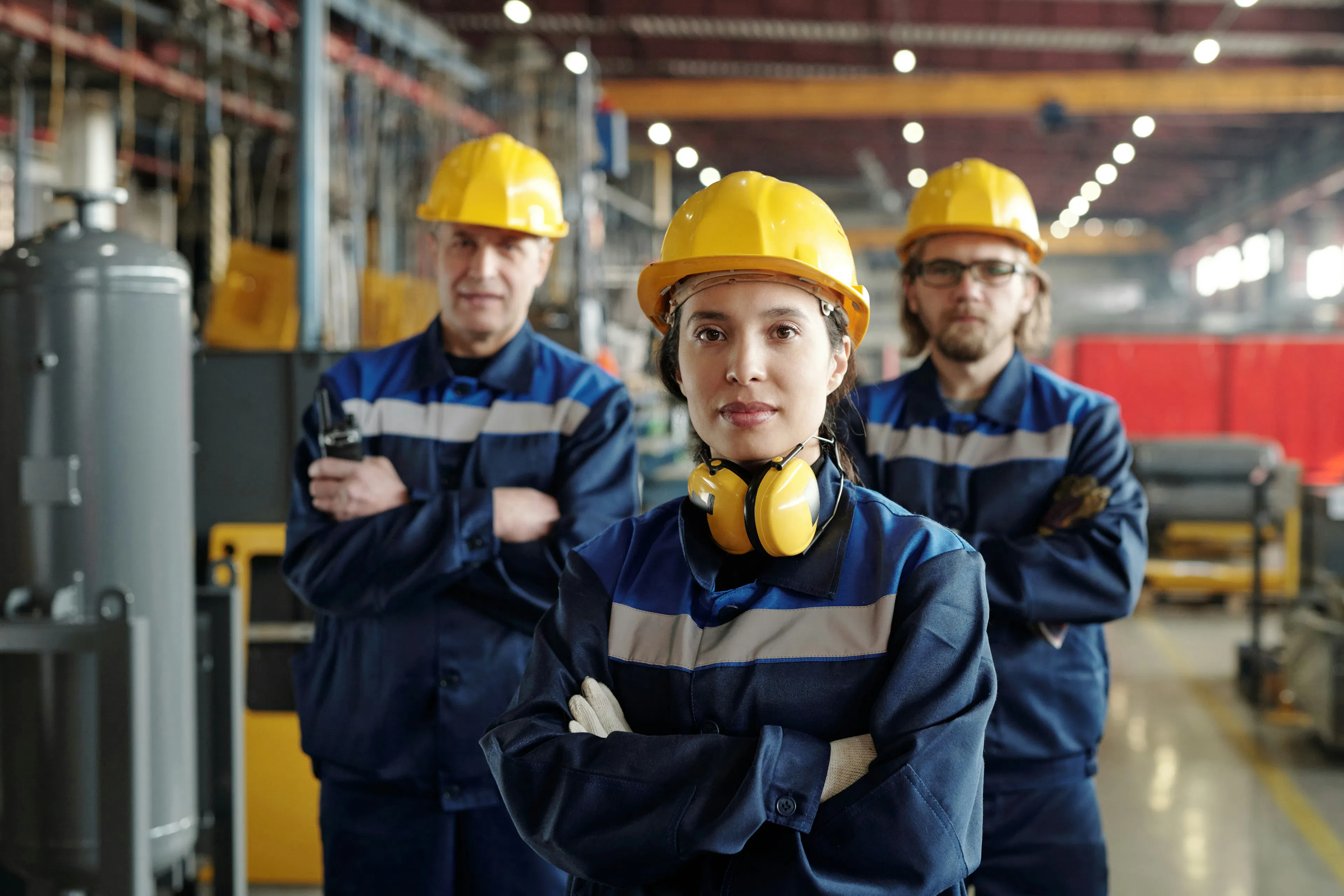 Factory workers in hard hats and safety workwear