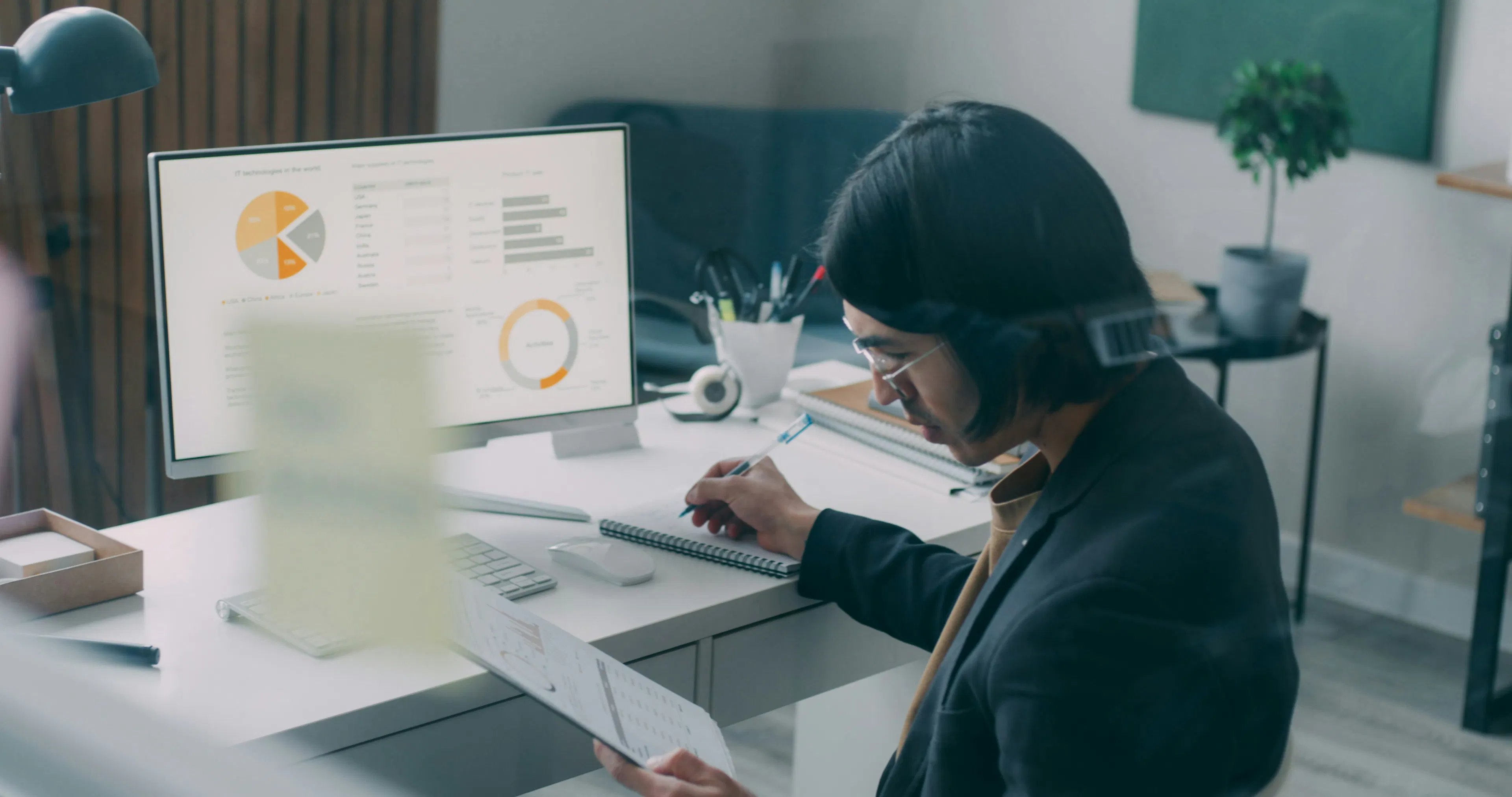 Professional reviewing workforce analytics data on a desktop monitor