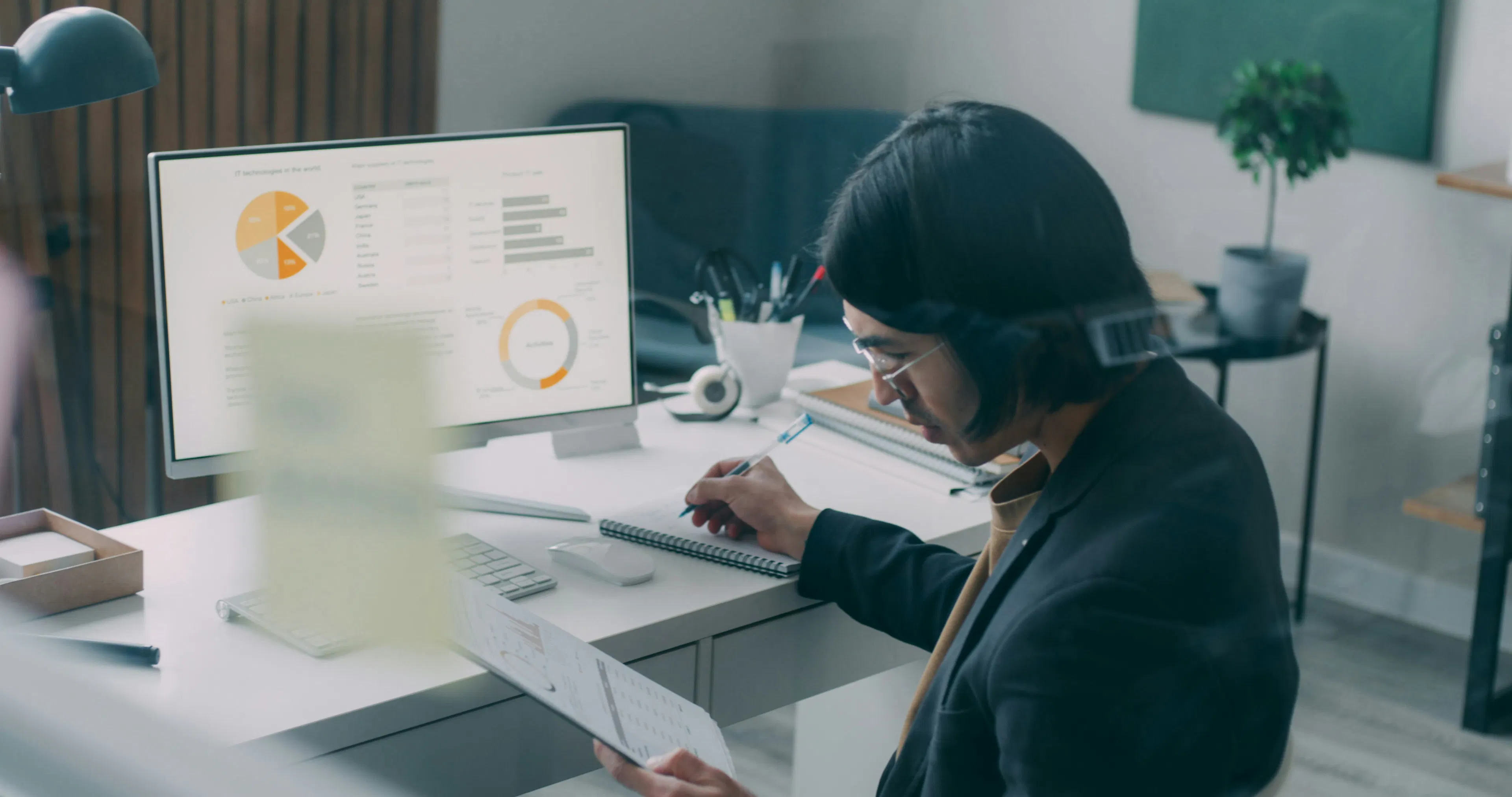 Professional reviewing workforce analytics data on a desktop monitor